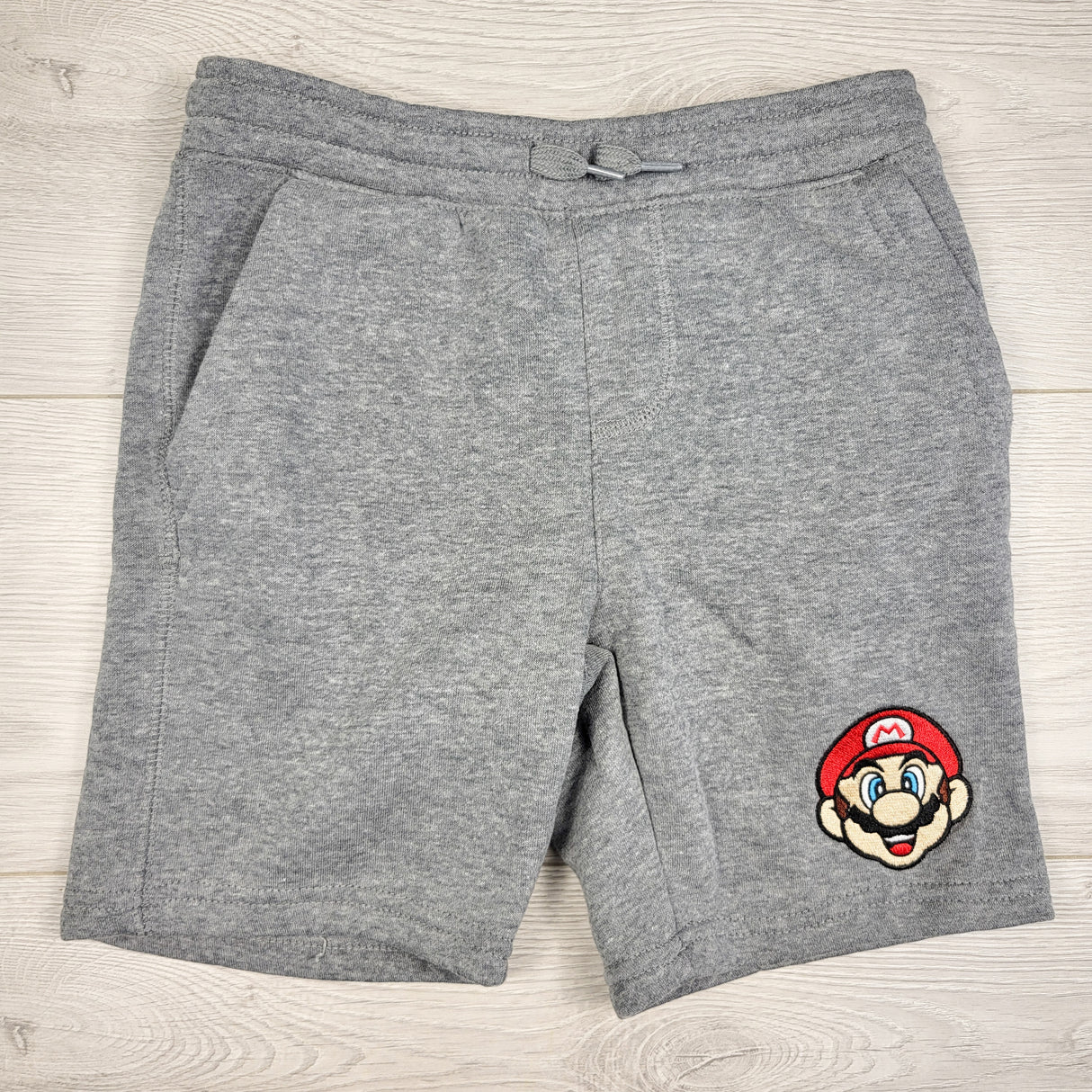 Old Navy grey fleecy lined Super Mario drawstring shorts. Size 6/7