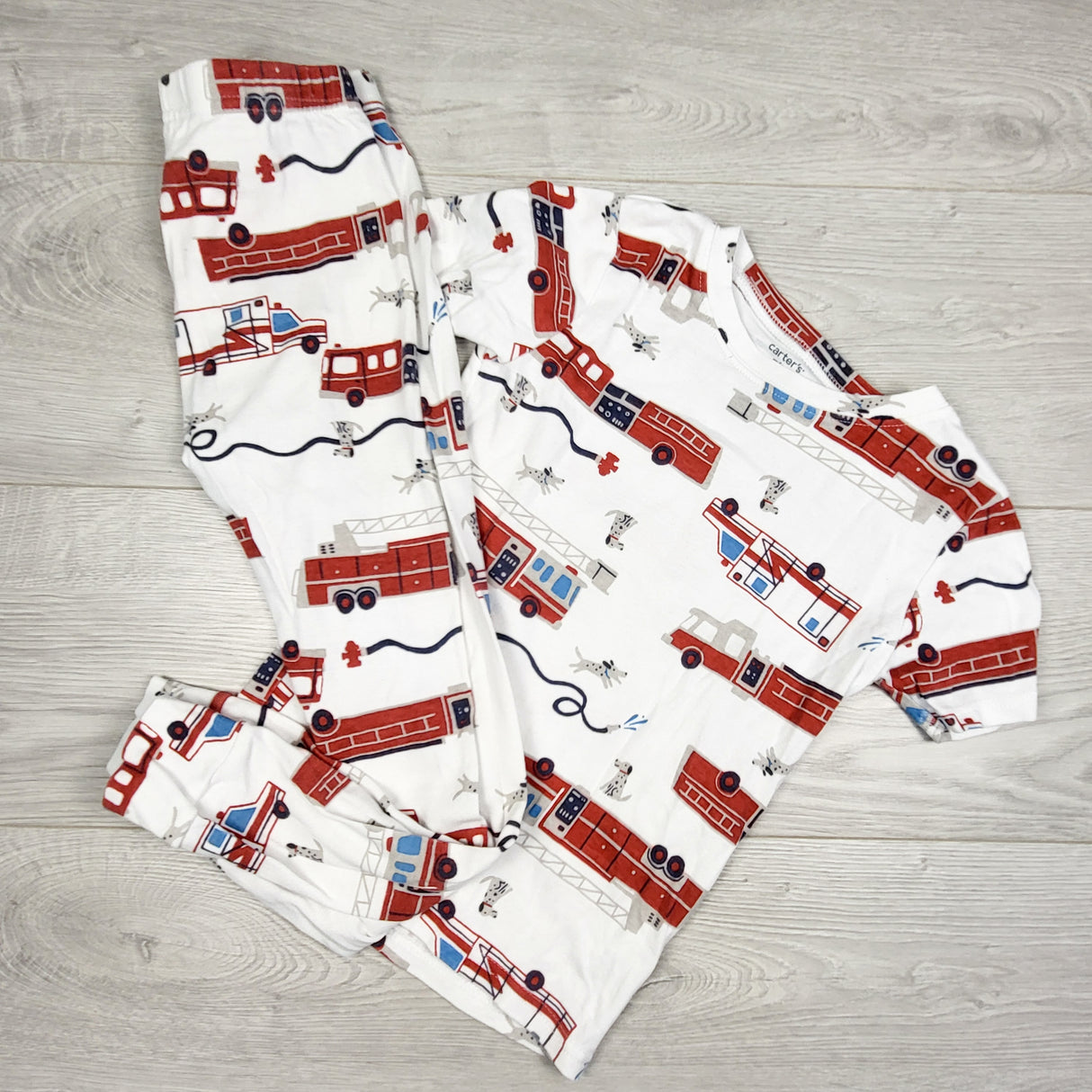 Carters white 2pc PJs with fire trucks. Size 7