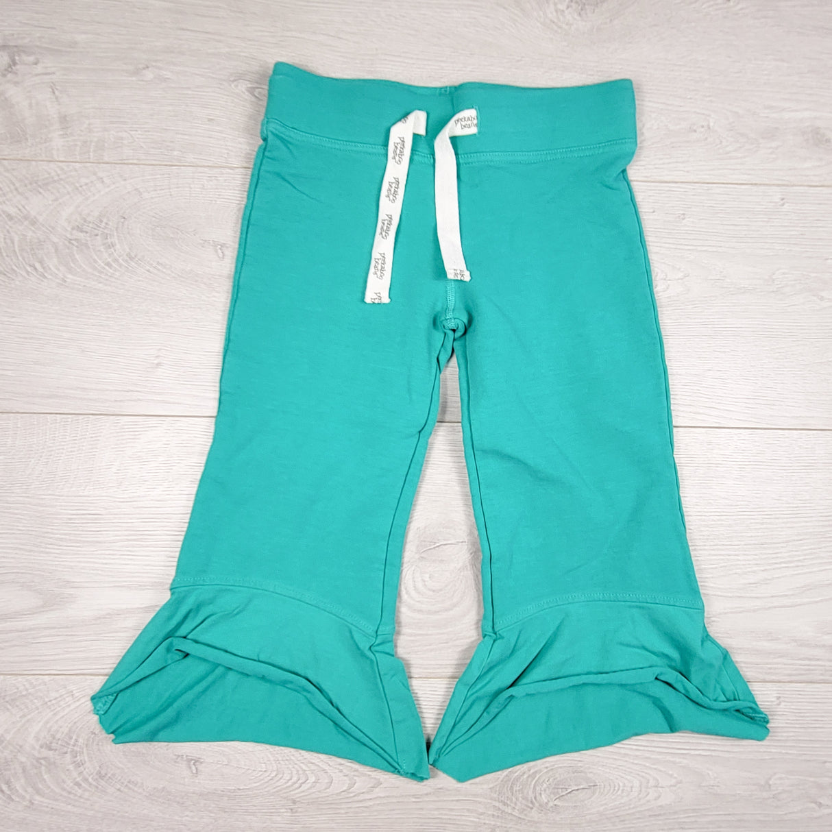 Peekaboo Beans turquoise cropped ruffle pants. Size 6