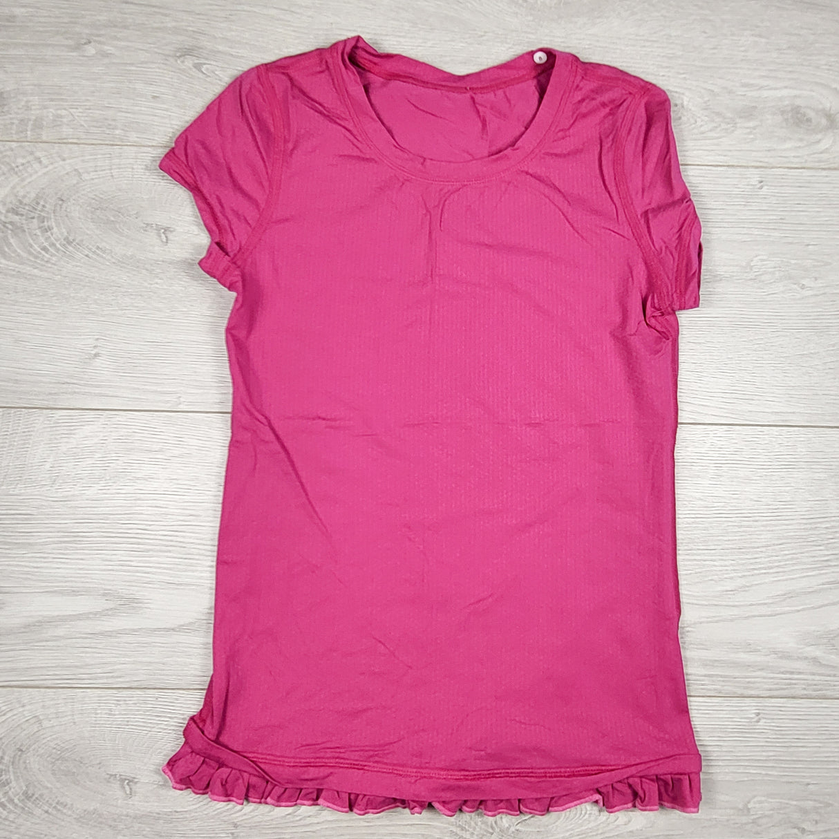 Ivivva (Lululemon) pink active t-shirt with ruffle hem. Size 8