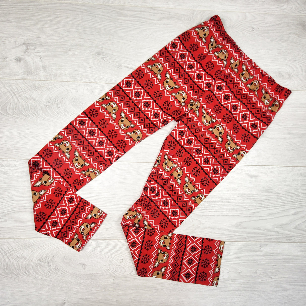 Rudolph the Red-Nosed Reindeer red patterned leggings. Size 10/12