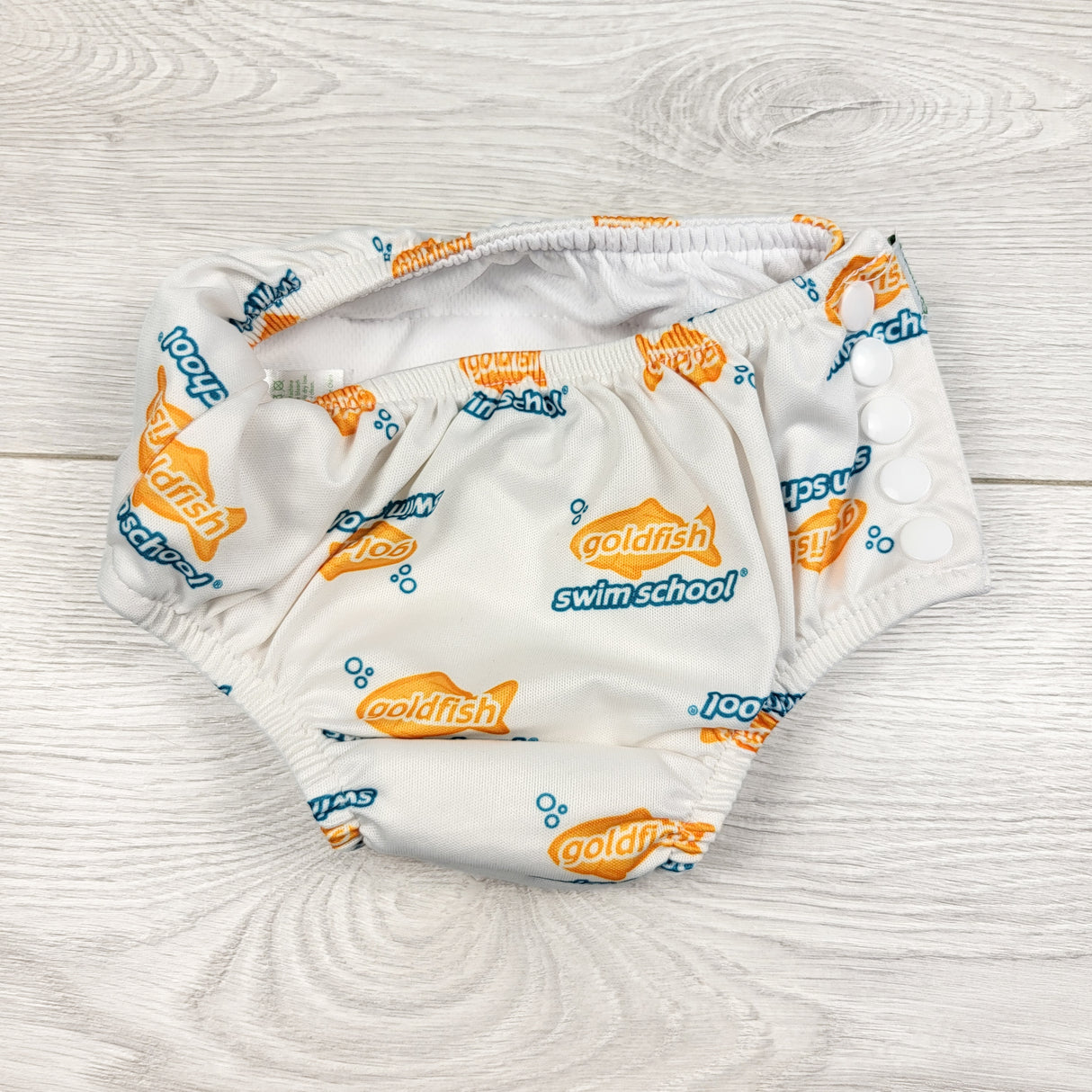 Swim School white reusable swim diaper with fish. Size 24 months