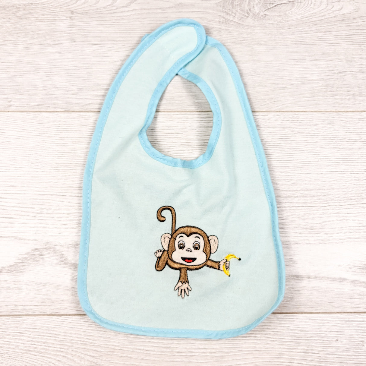 Buba Baby blue plastic backed bib with monkey.