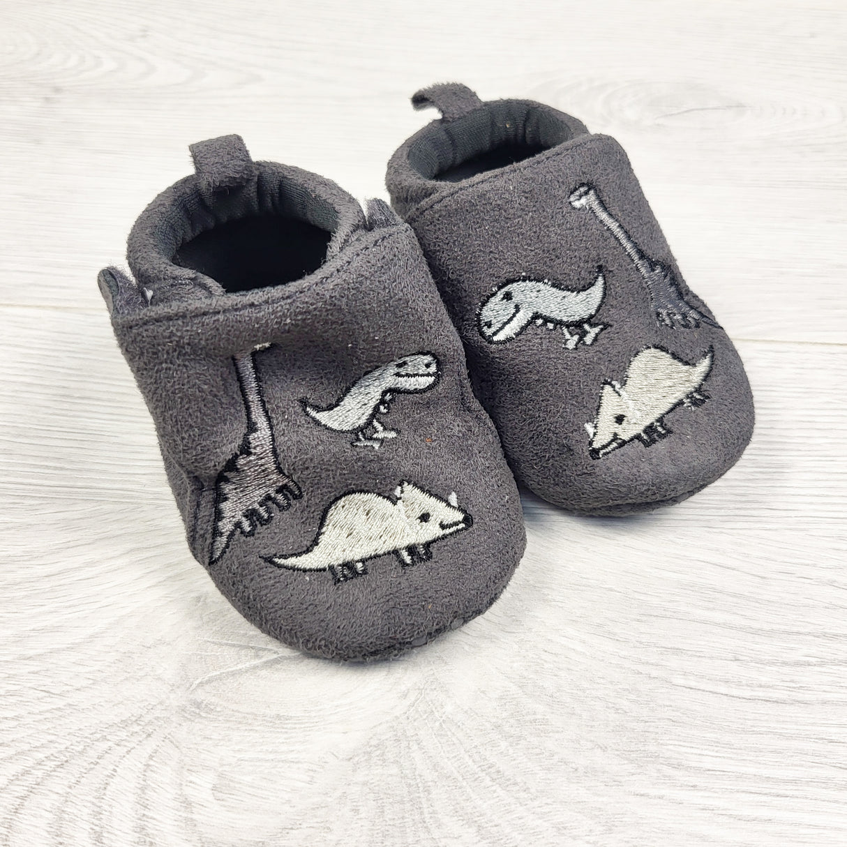 Joe grey dinosaur booties. Sizes like 0-3 months