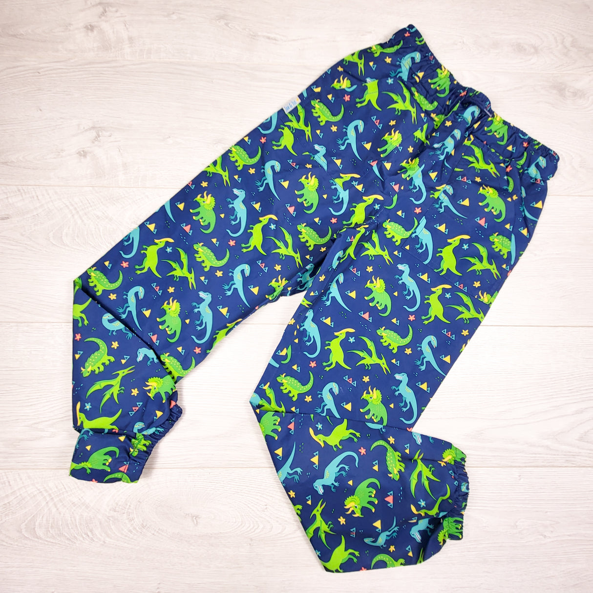Jan and Jul navy dinosaur print single layer rain pants. Approx size 10/12