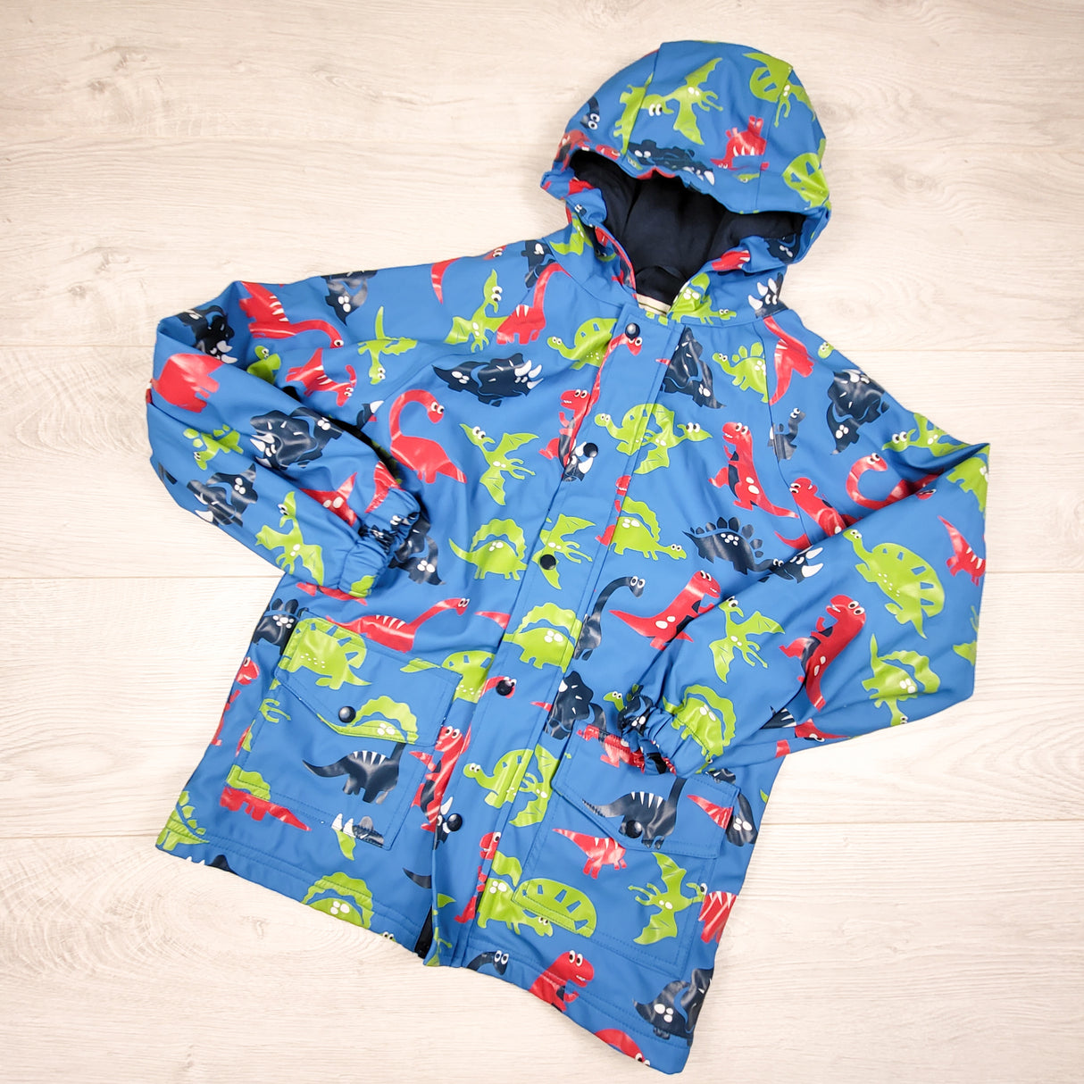 OAKI blue jersey lined dinosaur print rain jacket. Size 6/7