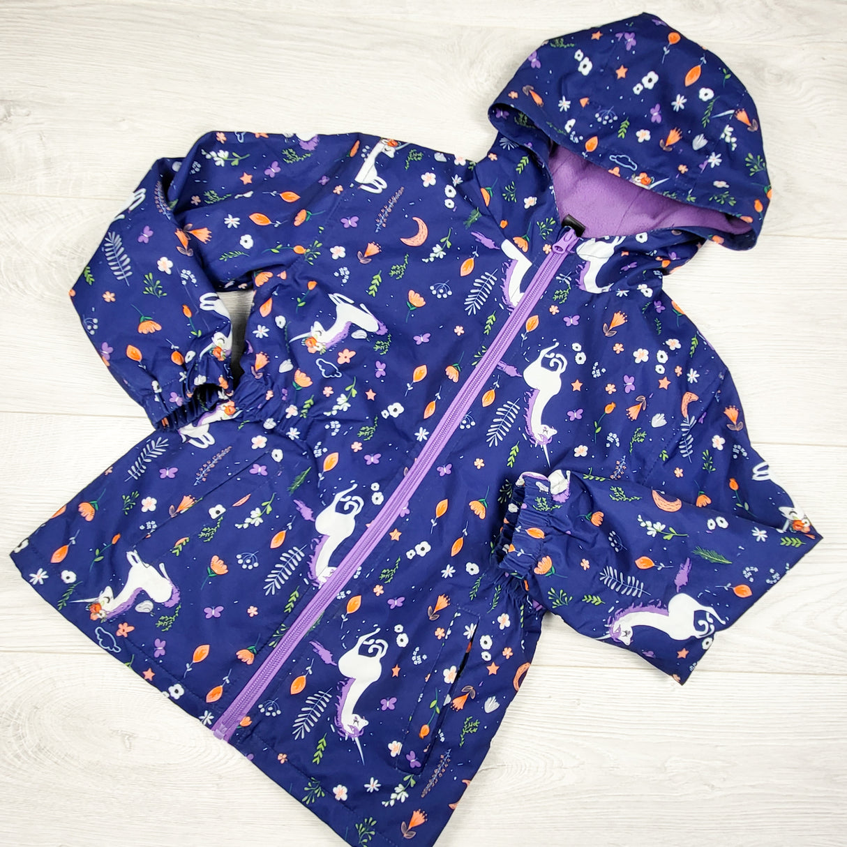 Navy unicorn patterned midweight fleece lined rain jacket. Size 6