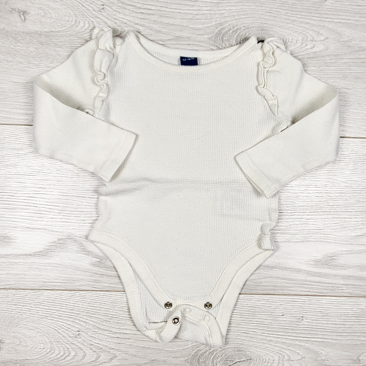 Old Navy white waffle knit bodysuit with ruffles. Size 12-18 months