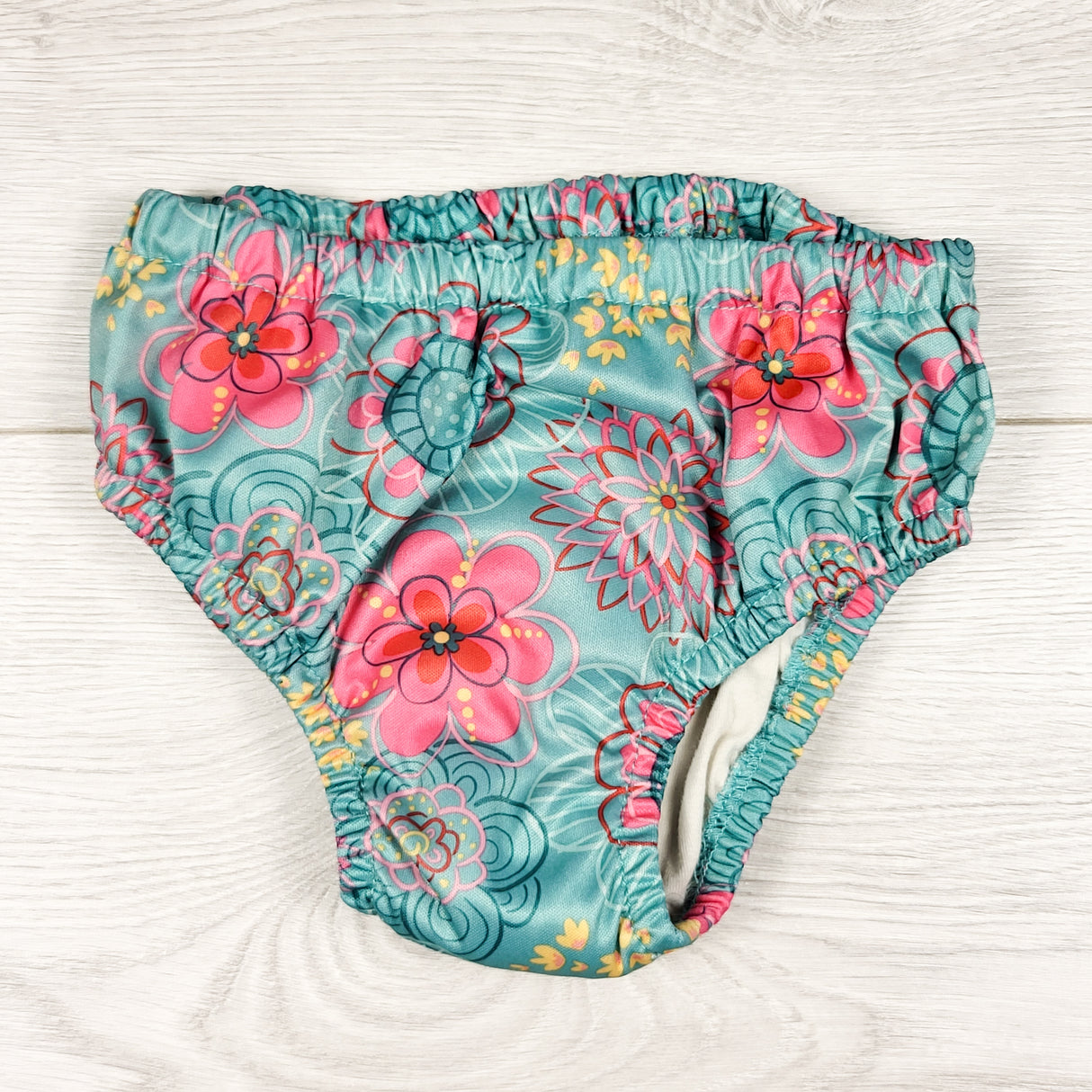 Charlie Banana teal floral print reusable swim diaper. Size XL (27 to 55lbs)