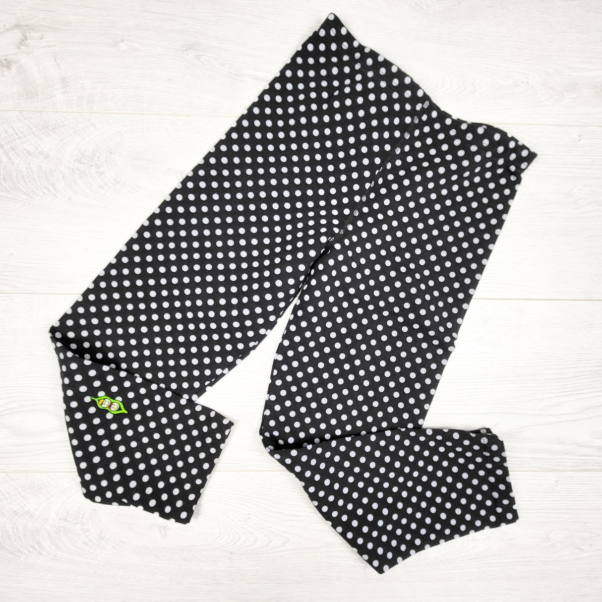 Peekaboo Beans black polka dot leggings. Size 8