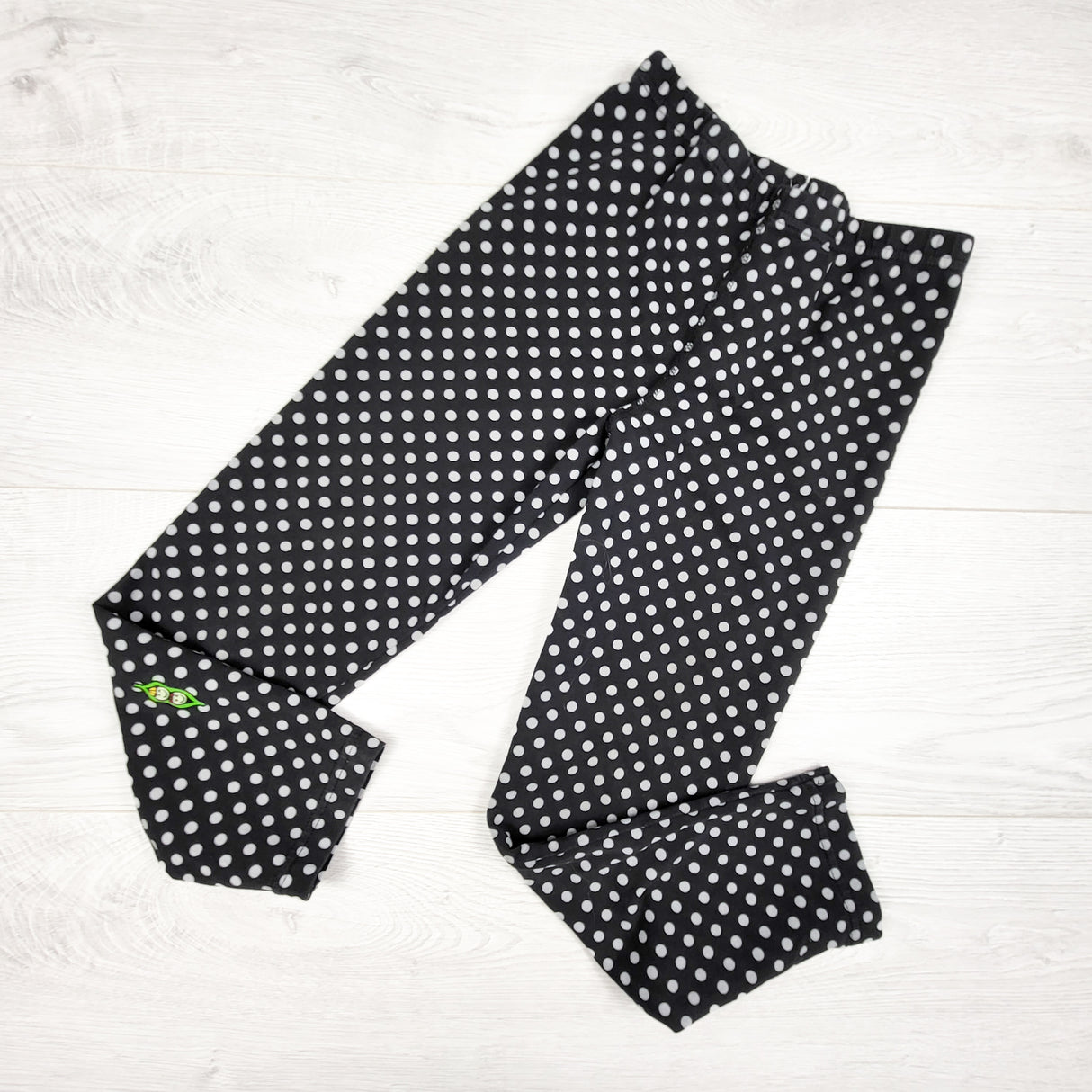 Peekaboo Beans black polka dot leggings. Size 8
