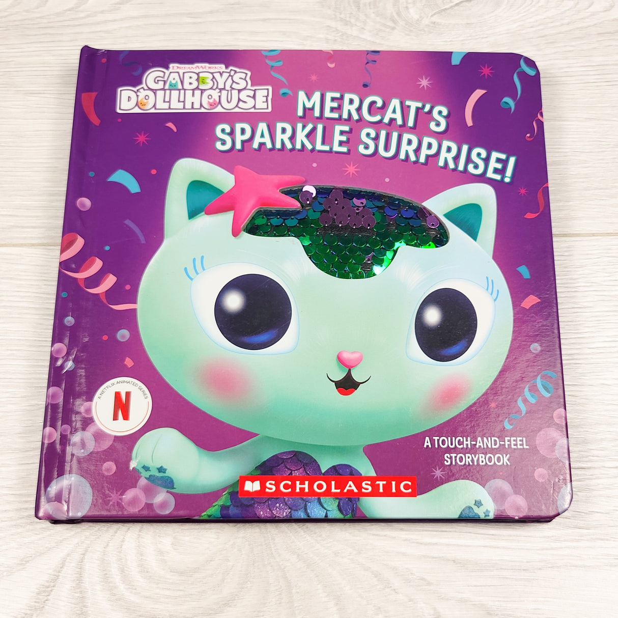 Mercat's Sparkle Surprise. Gabby's Dollhouse touch and feel board book