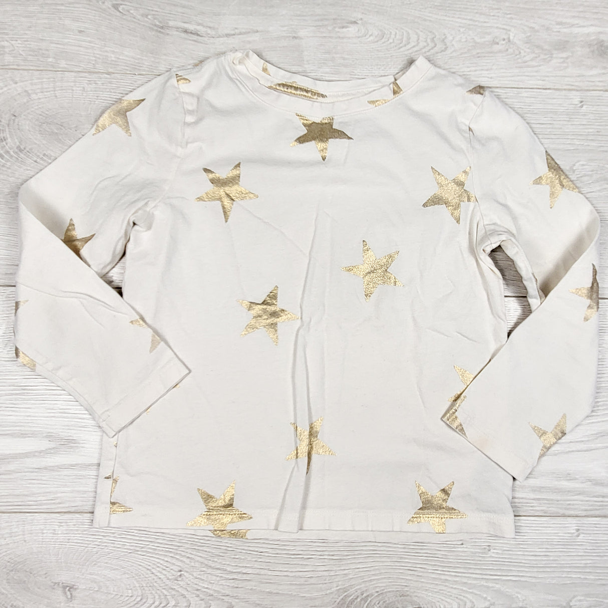 Old Navy cream coloured top with gold stars. Size 6/7