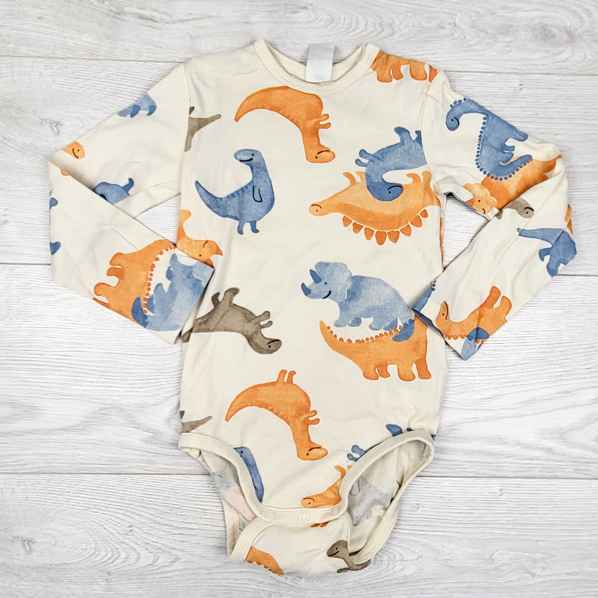 Old Navy cream coloured bodysuit with dinosaurs. Size 3/4T