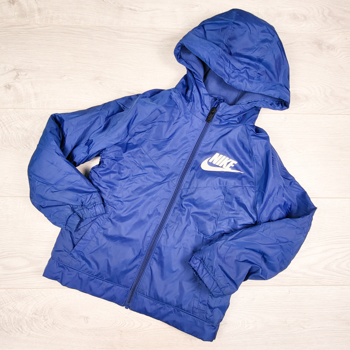 Nike blue fleece lined hooded windbreaker jacket. Size 6/7