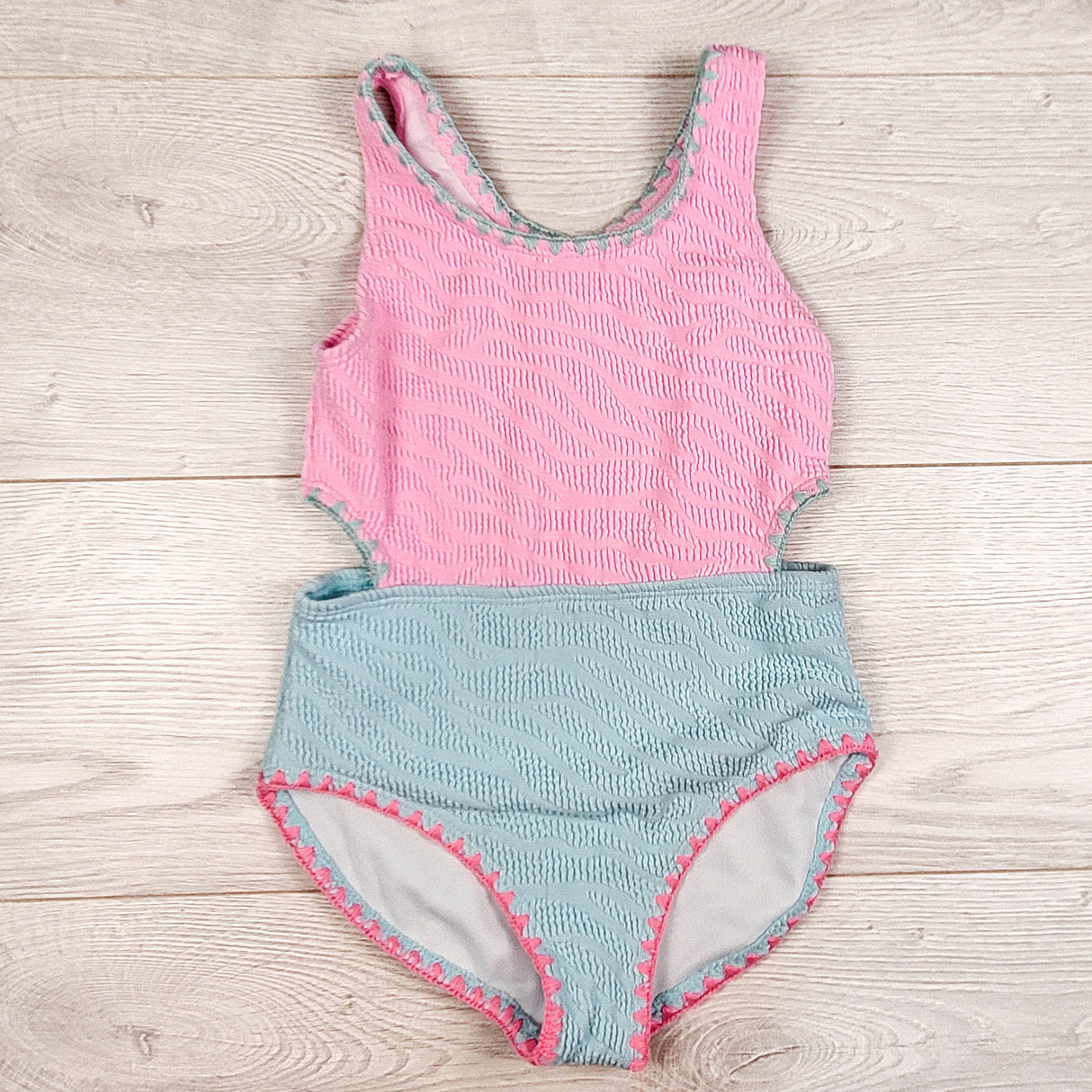 BMagical pink and blue textured one piece cut-out style swimsuit. Size 4/5T