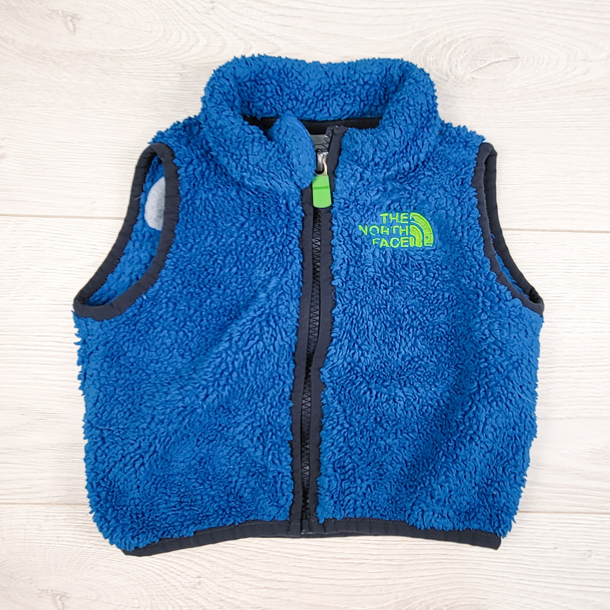 The North Face blue sherpa fleece vest. Size 3-6 months