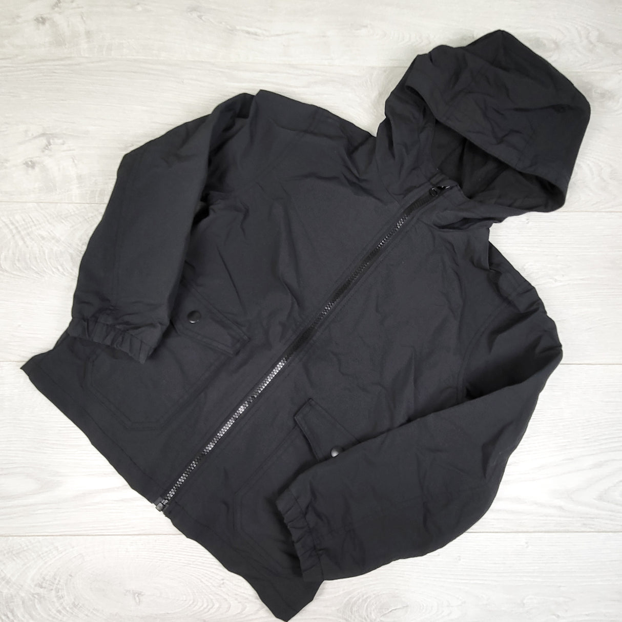 Old Navy black zip up rain jacket. Size 6/7