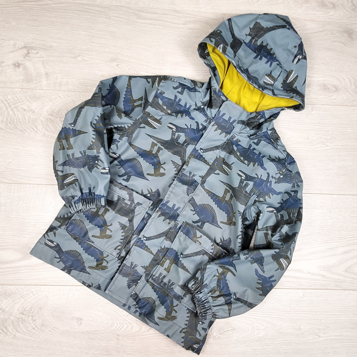 Old Navy blue jersey lined rain jacket with dinosaurs. Size 5T