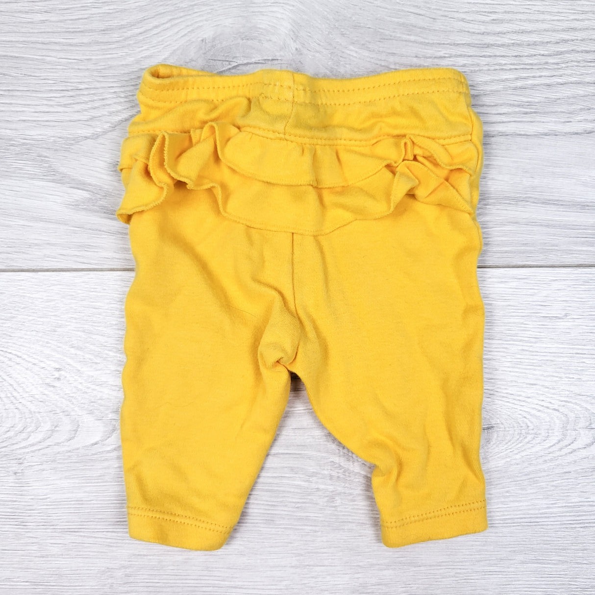 Child of Mine yellow ruffle bum leggings. Newborn size