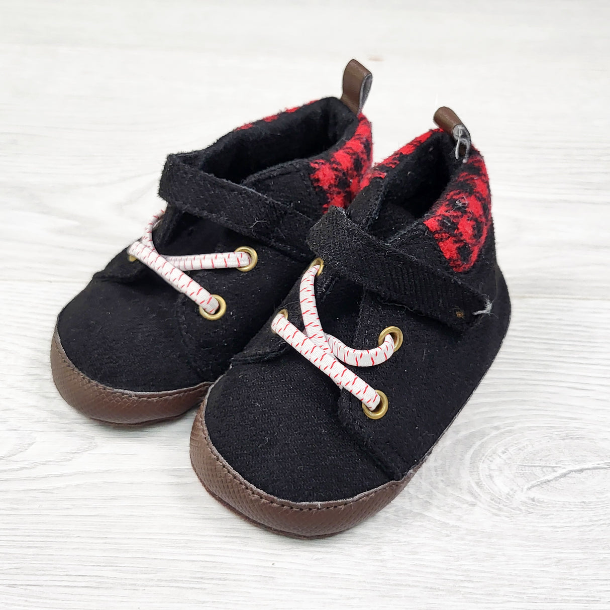 Carters black soft soled shoes with plaid trim. Size 6-9 months