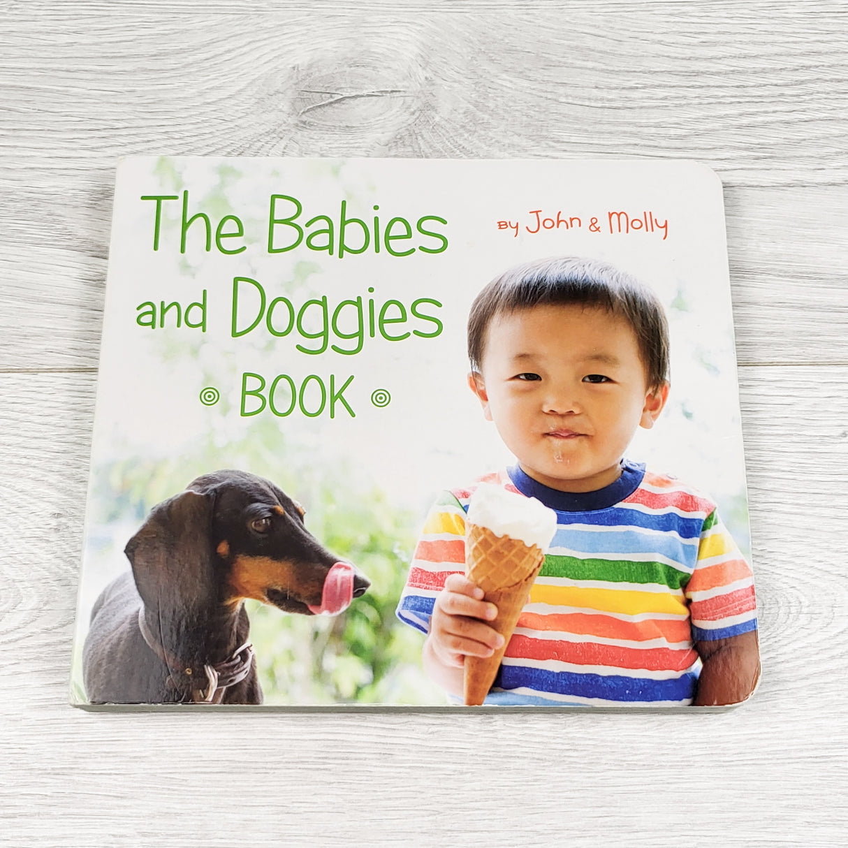 The Babies and Doggies book. Board book