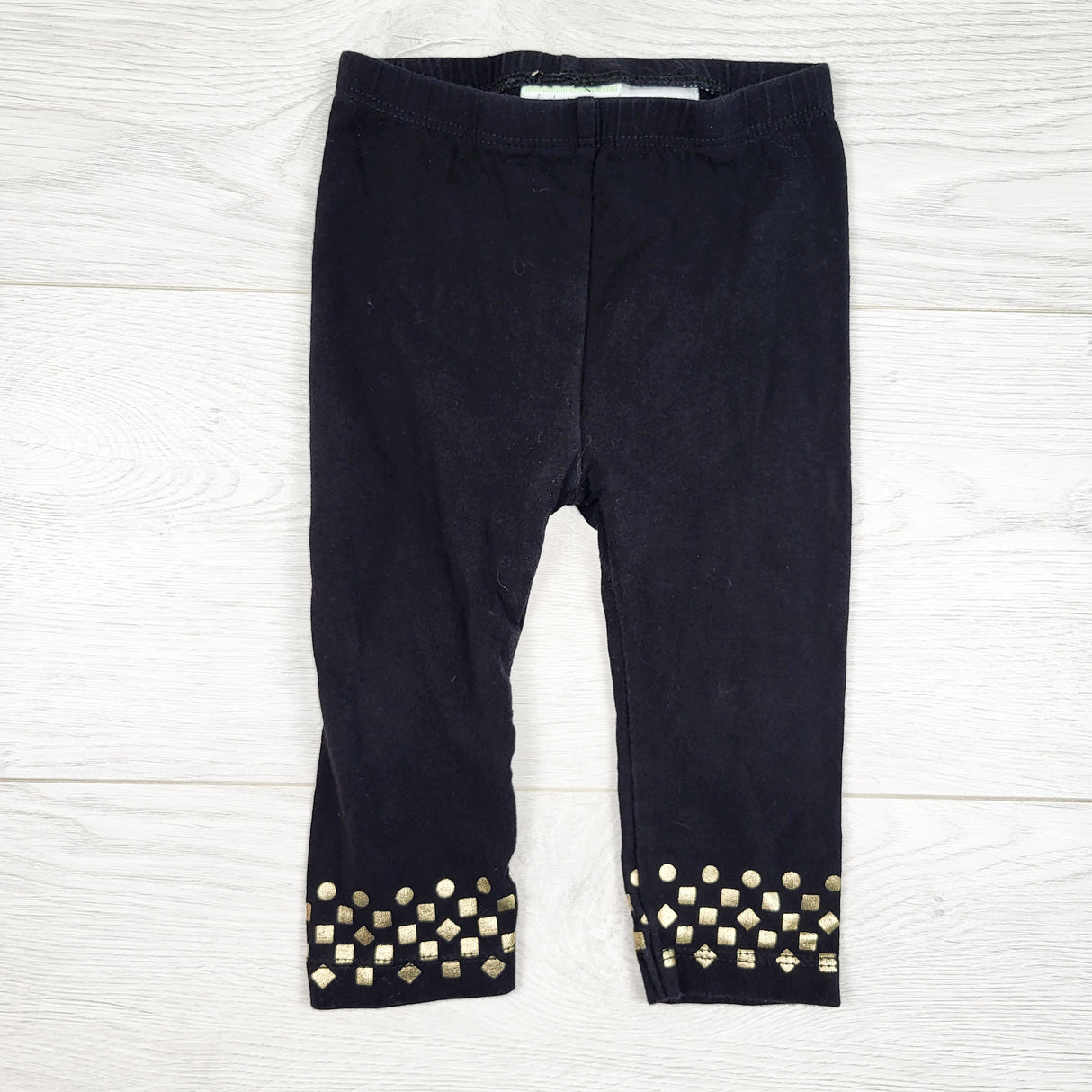 First Impressions black leggings with gold accents. Size 6-9 months
