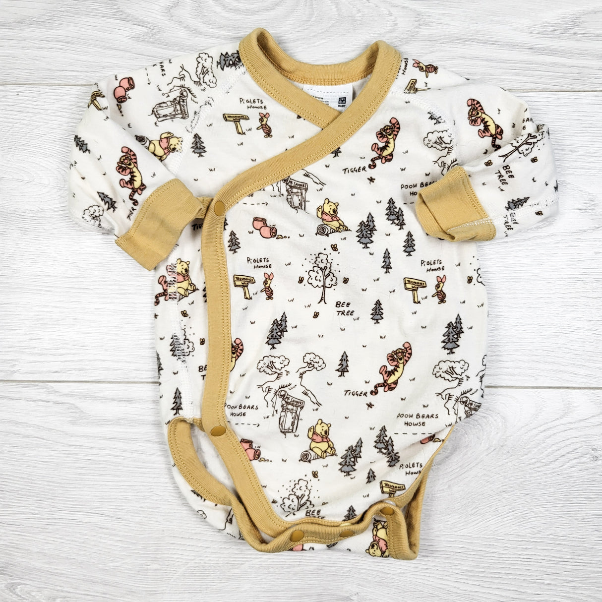 Uniqlo white and golden yellow Winnie the Pooh wrap style bodysuit. Size 3-6 months