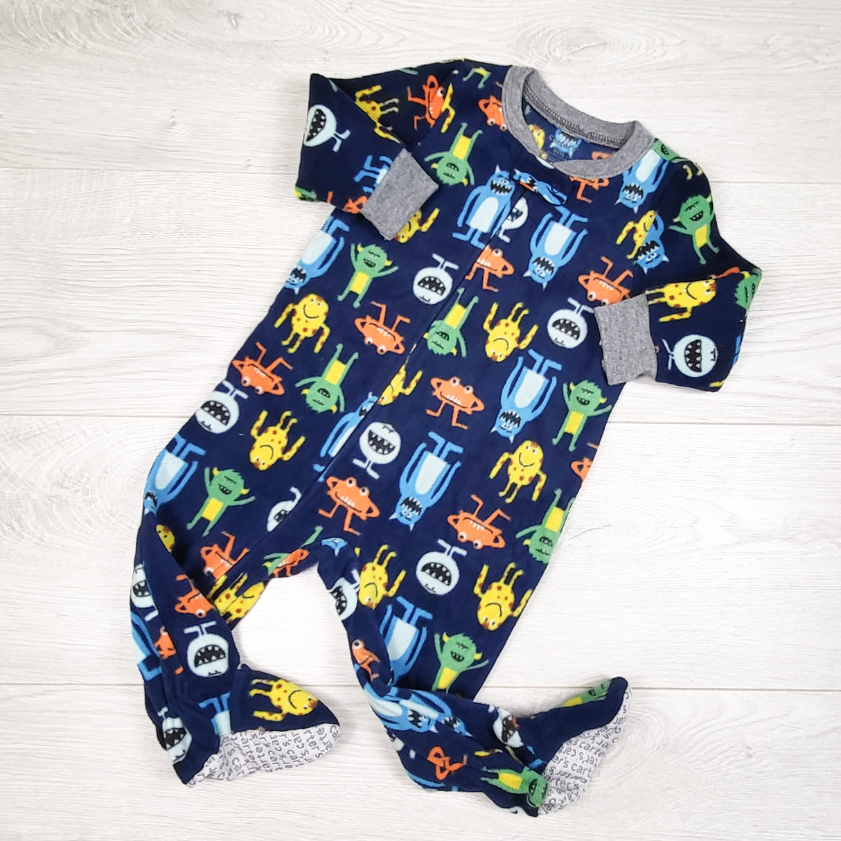Carters navy zippered fleece sleeper with monsters. Size 9 months