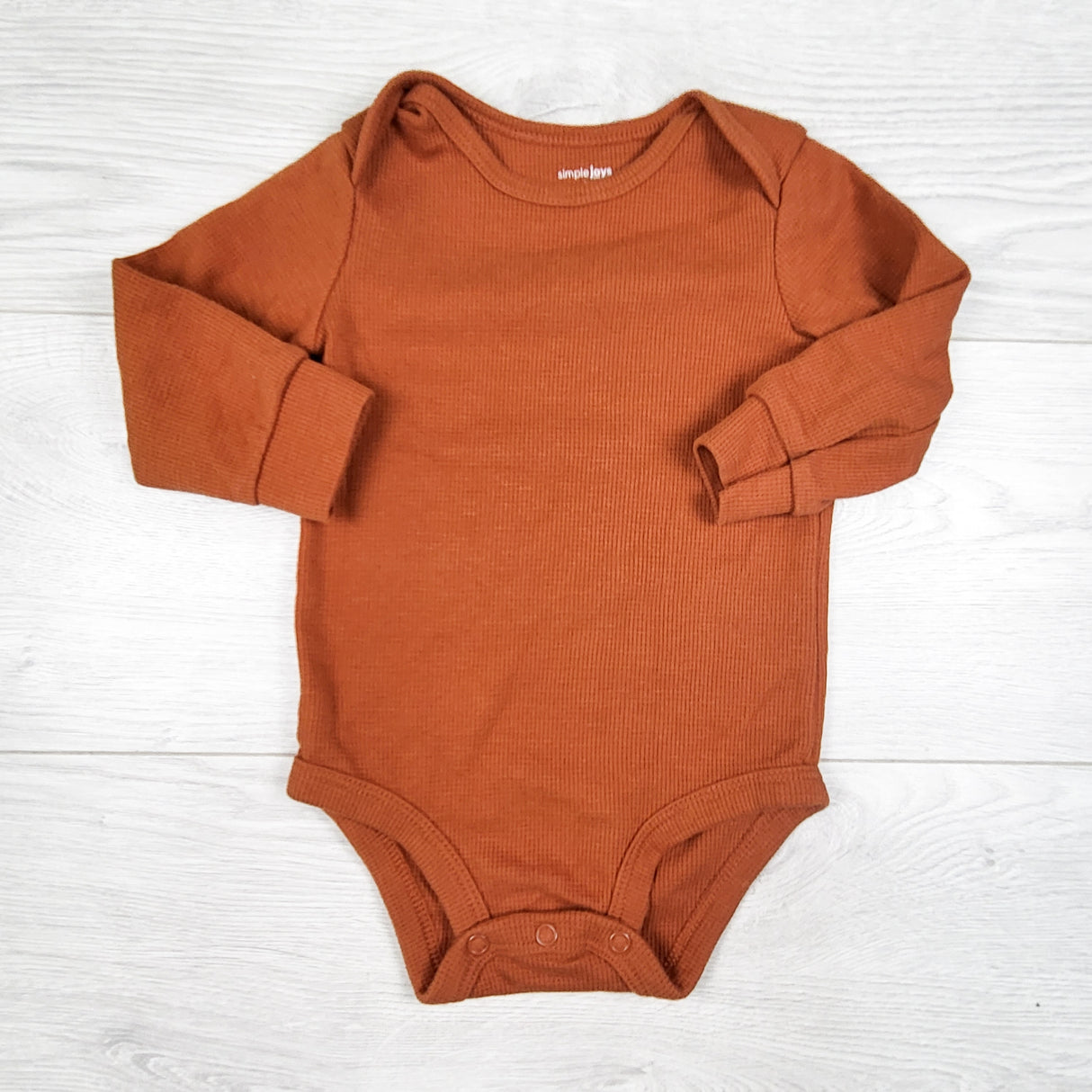 Simple Joys pumpkin coloured waffle knit bodysuit. Size 6-9 months