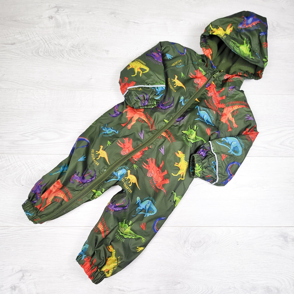 Mountain Warehouse green fleece lined dinosaur print one piece rainsuit. Size 9-12 months
