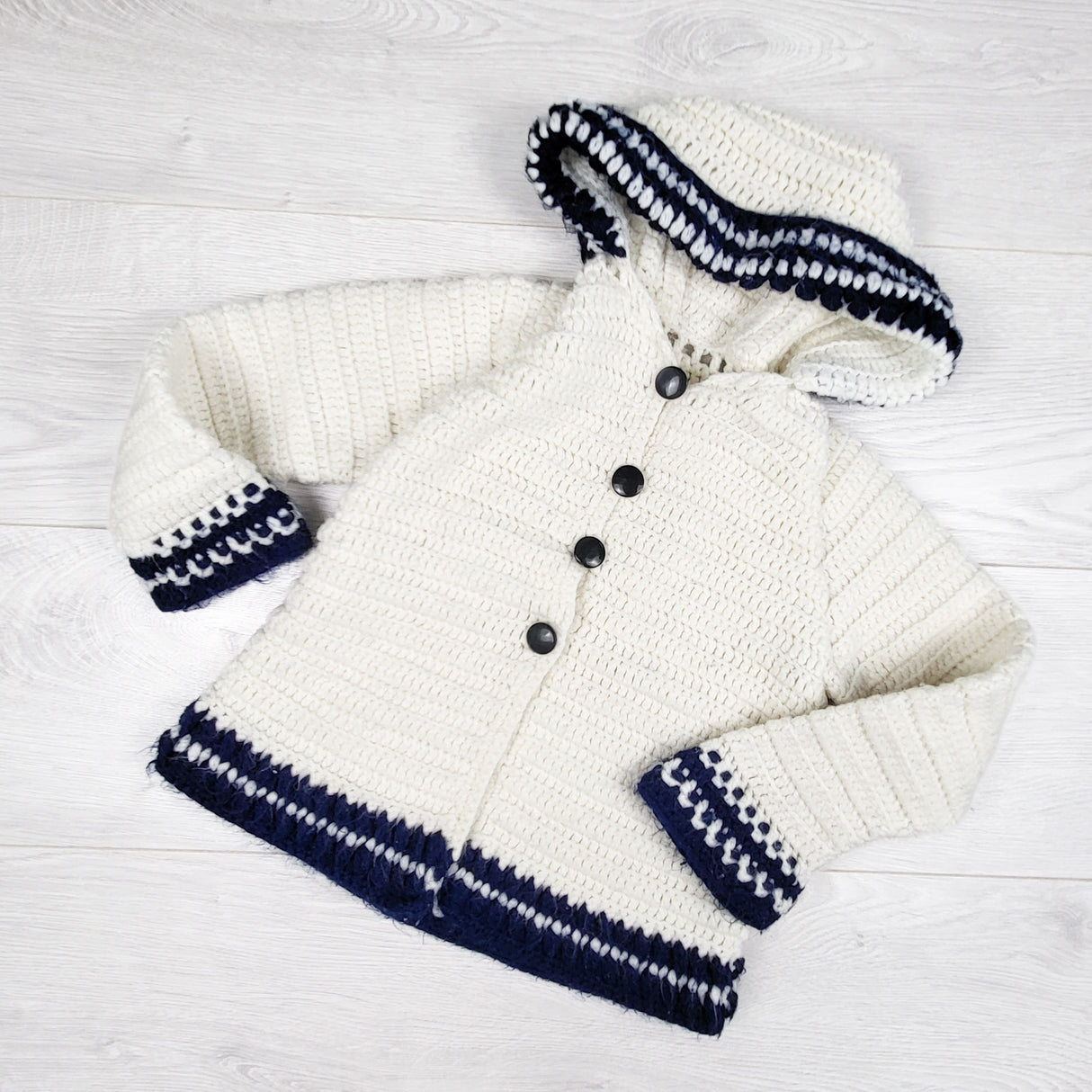 White and navy sweater with pixie hood. Approx 3/4T