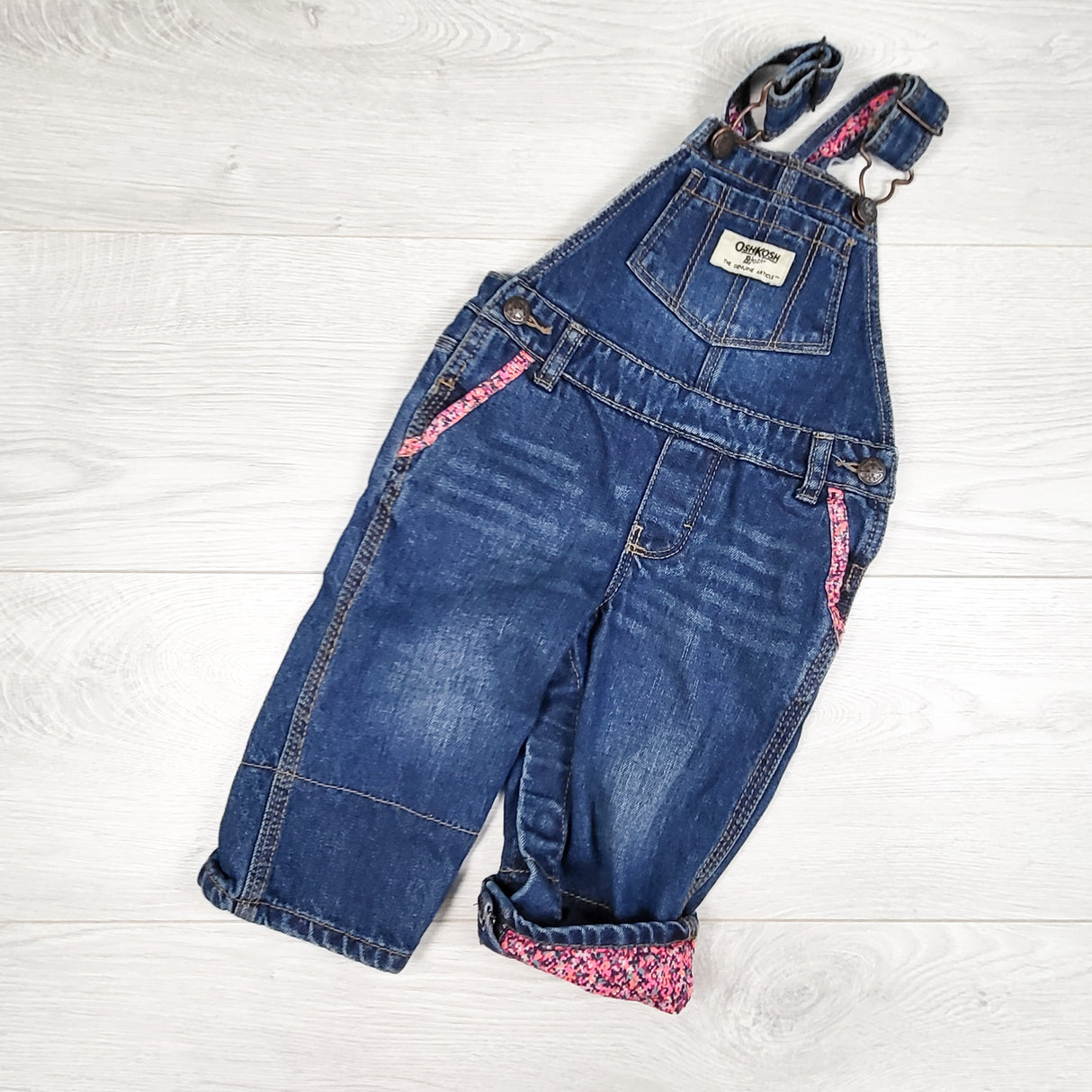 Oshkosh denim overalls with floral trim. Size 9 months