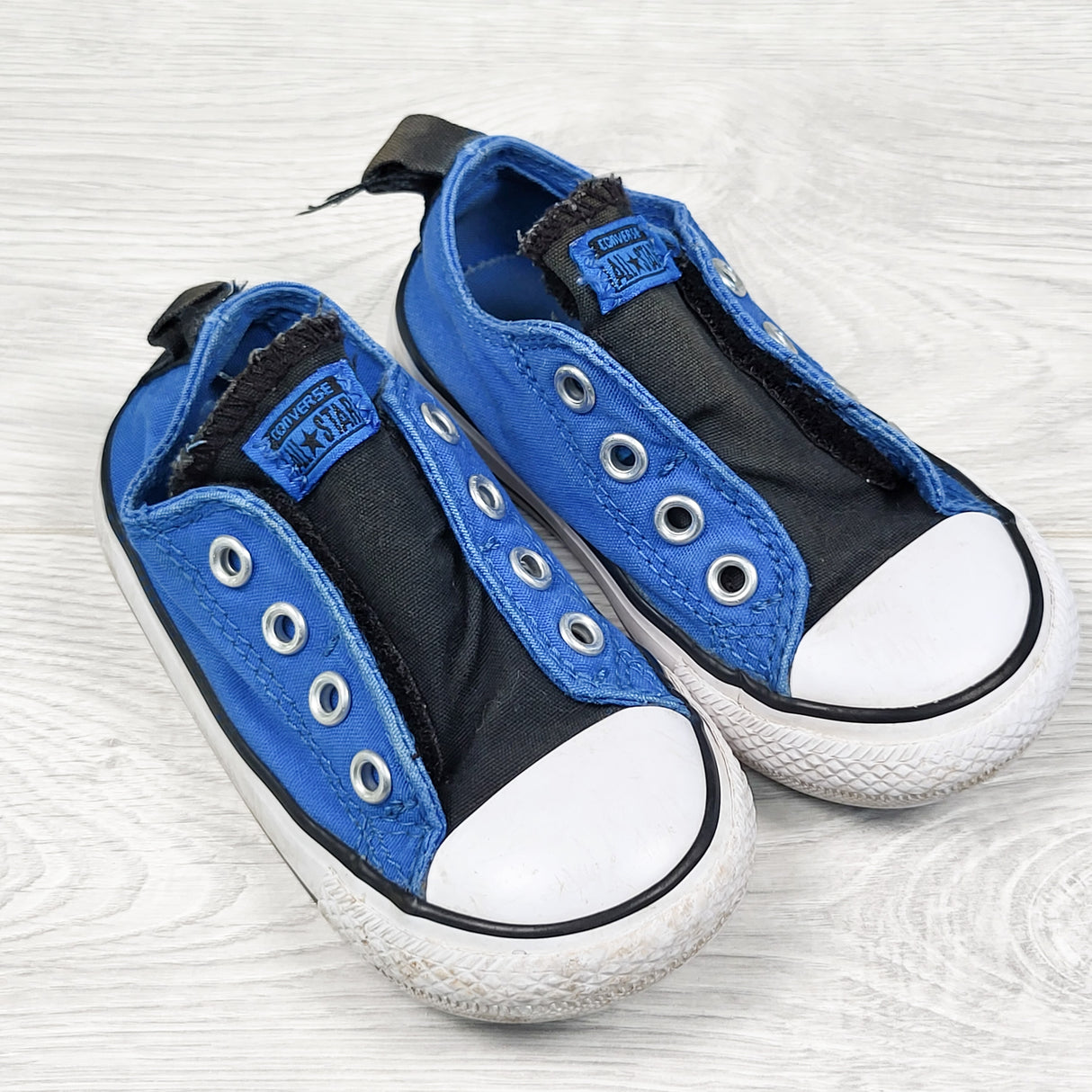 Converse black and blue slip on shoes with velcro closure. Size 6