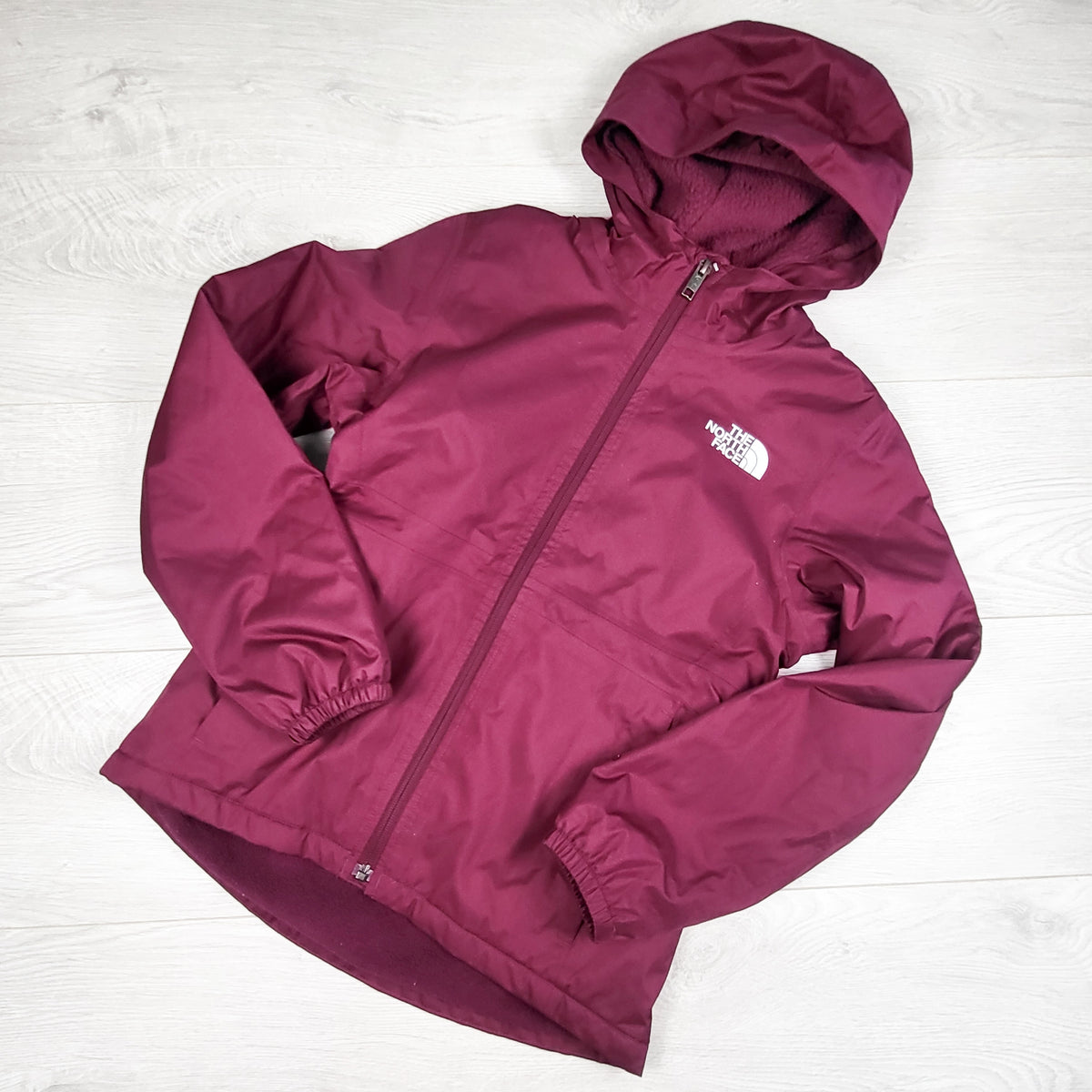 The North Face berry coloured fleece lined "warm storm" jacket. Size 10