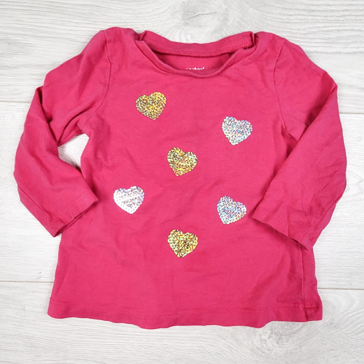 Carters pink top with glitter hearts. Size 9 months