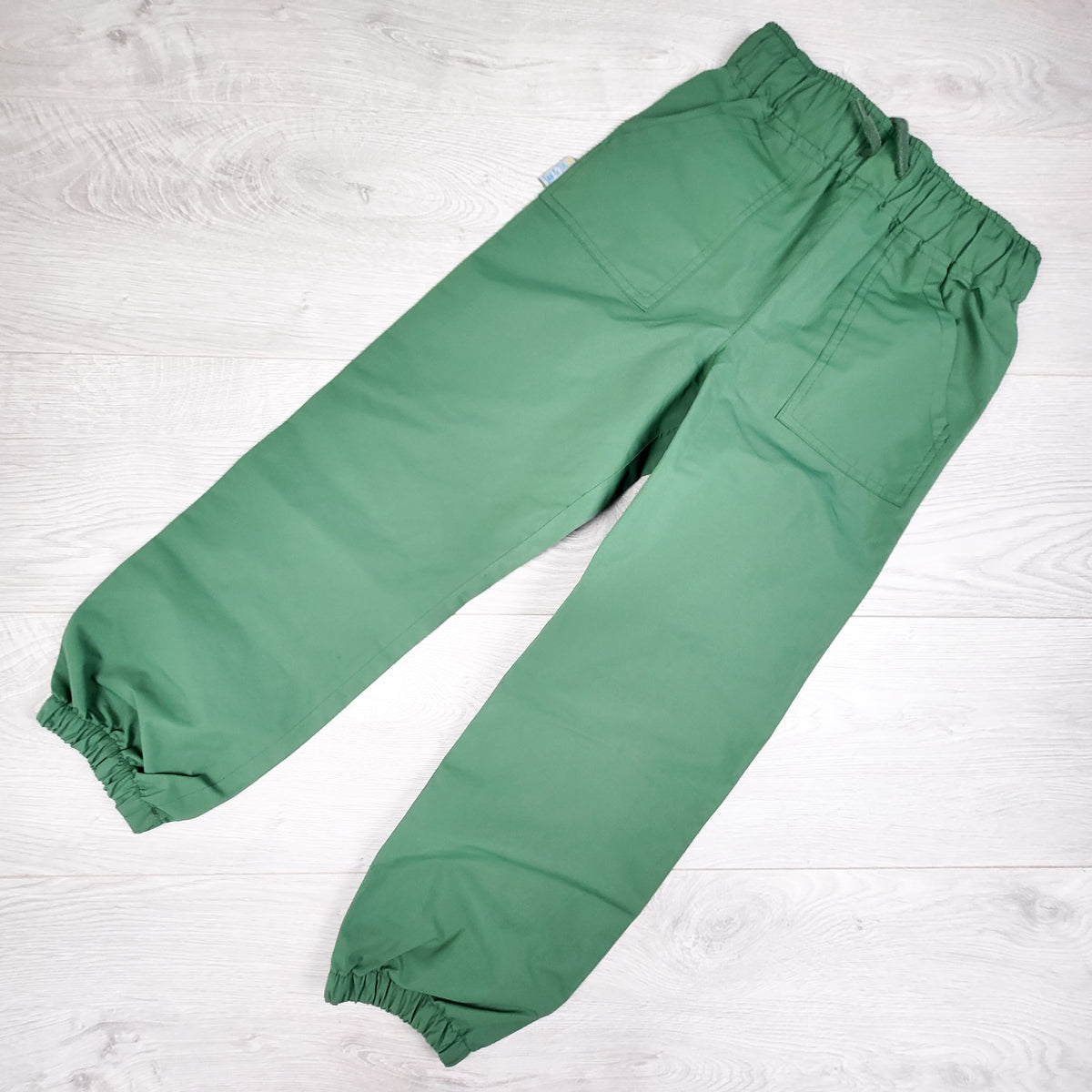 Jan and Jul green single layer rain pants. Size 6