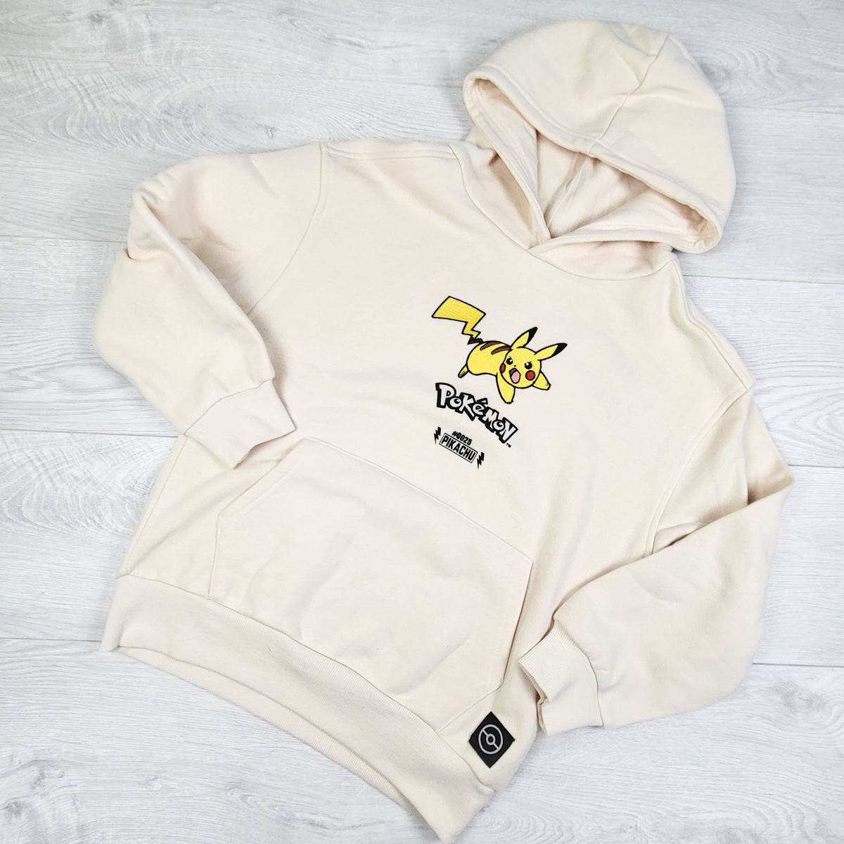 Pokemon cream coloured fleece lined pullover Pikachu hoodie. Size 7/8