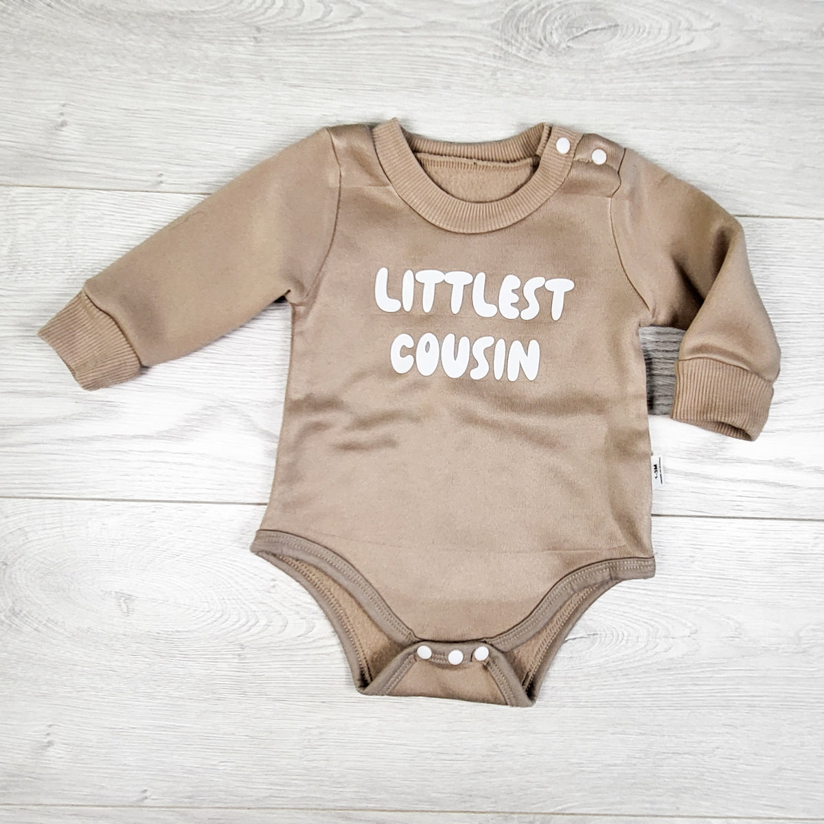 Beige fleecy lined "Littlest Cousin" romper. Size 1-3 months