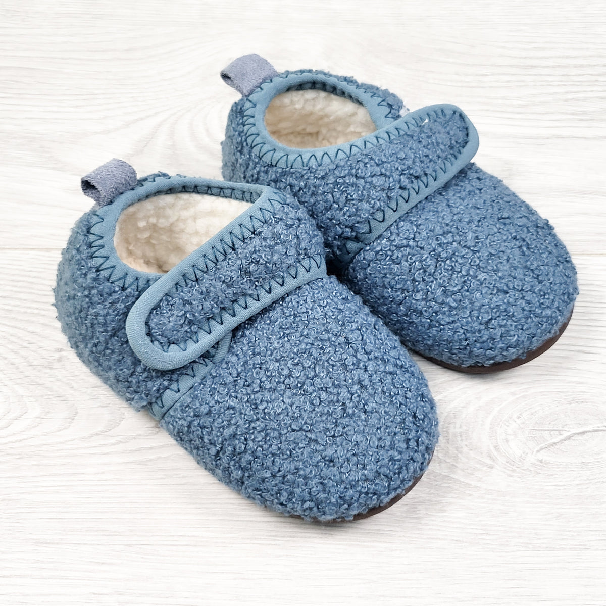 Blue sherpa slippers with rubber soles. Size like a 5/6
