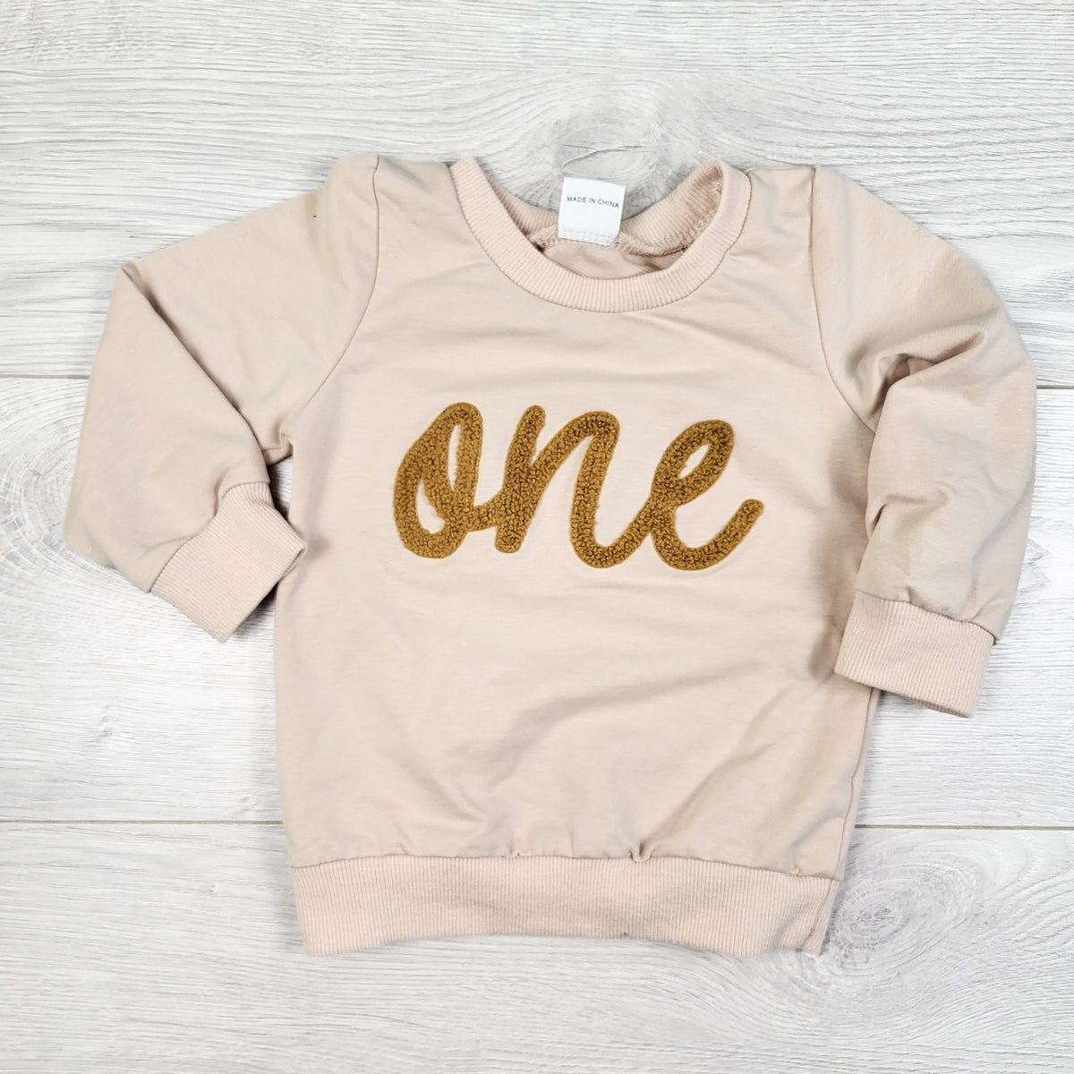 Beige sweatshirt with chenille "one". Size12-18 months