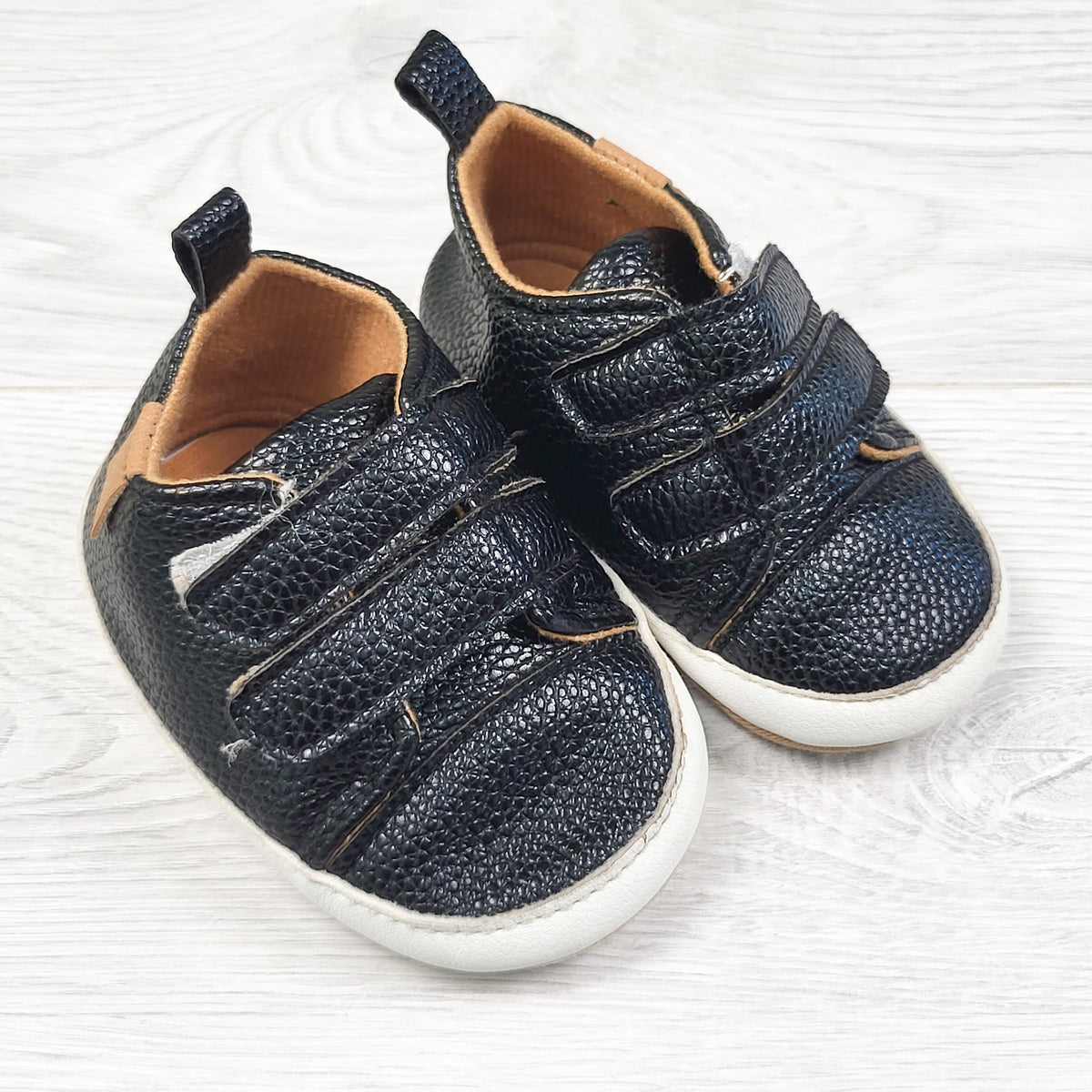 Myggpp black soft soled shoes. Sizes like an infant size 2