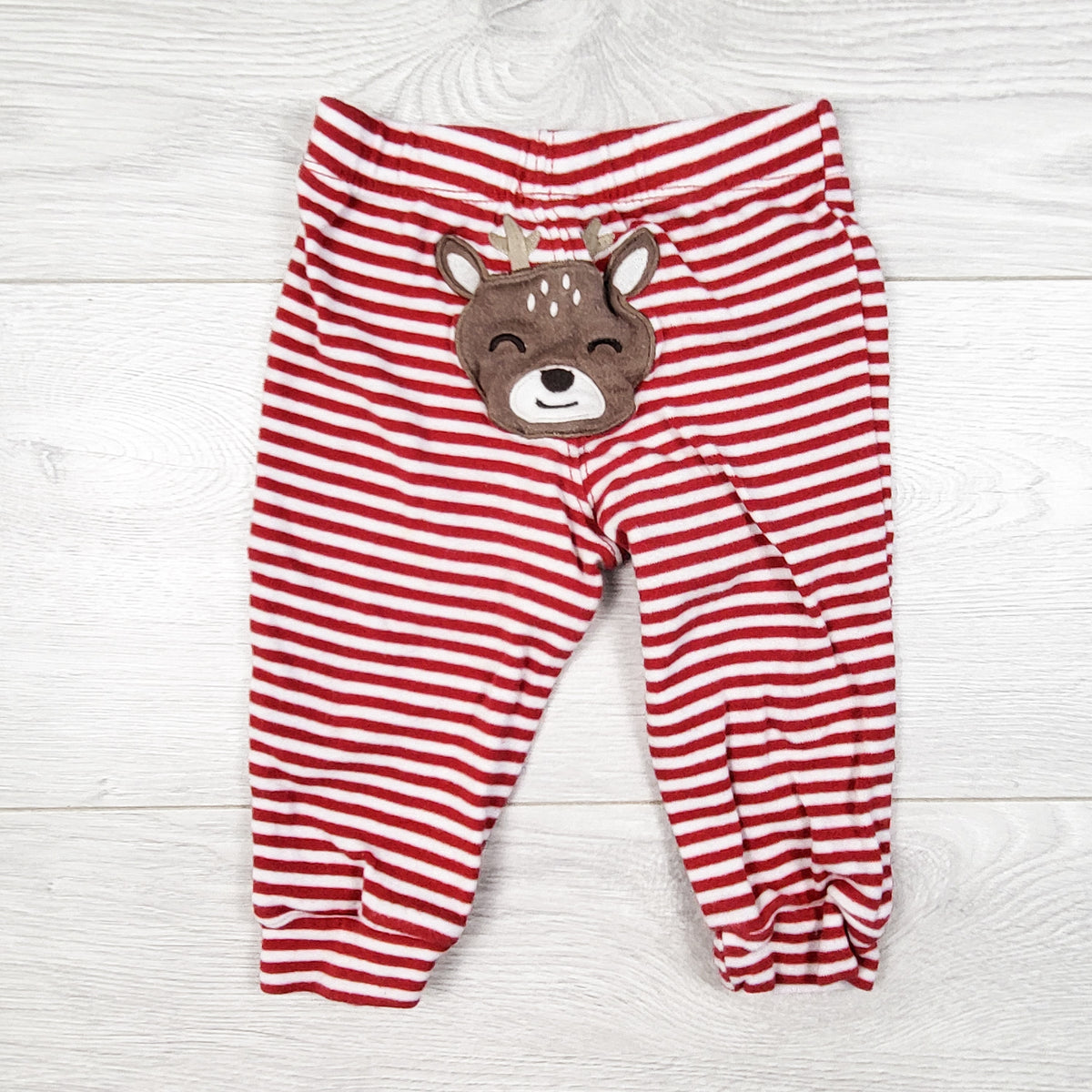 Carters red striped cotton pants with reindeer bum. Size 9 months