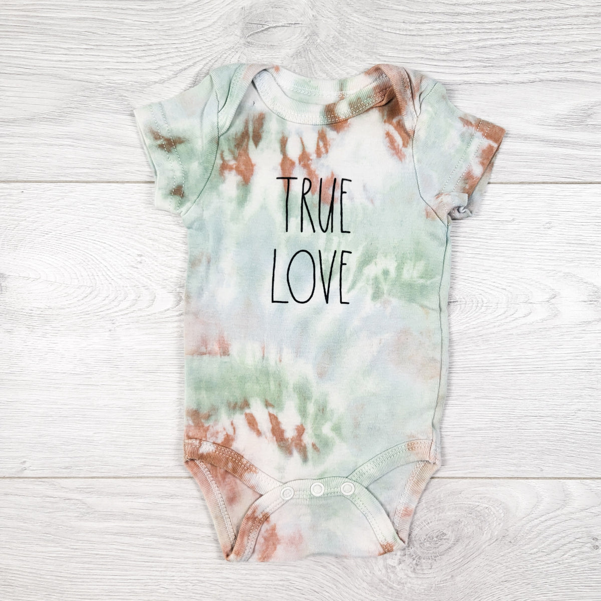 Rae Dunn Baby tie dyed "True Love" bodysuit. Size 0-3 months