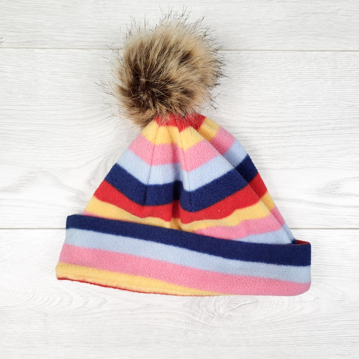 Striped fleece pom pom toque. Seems sized for bigger kids