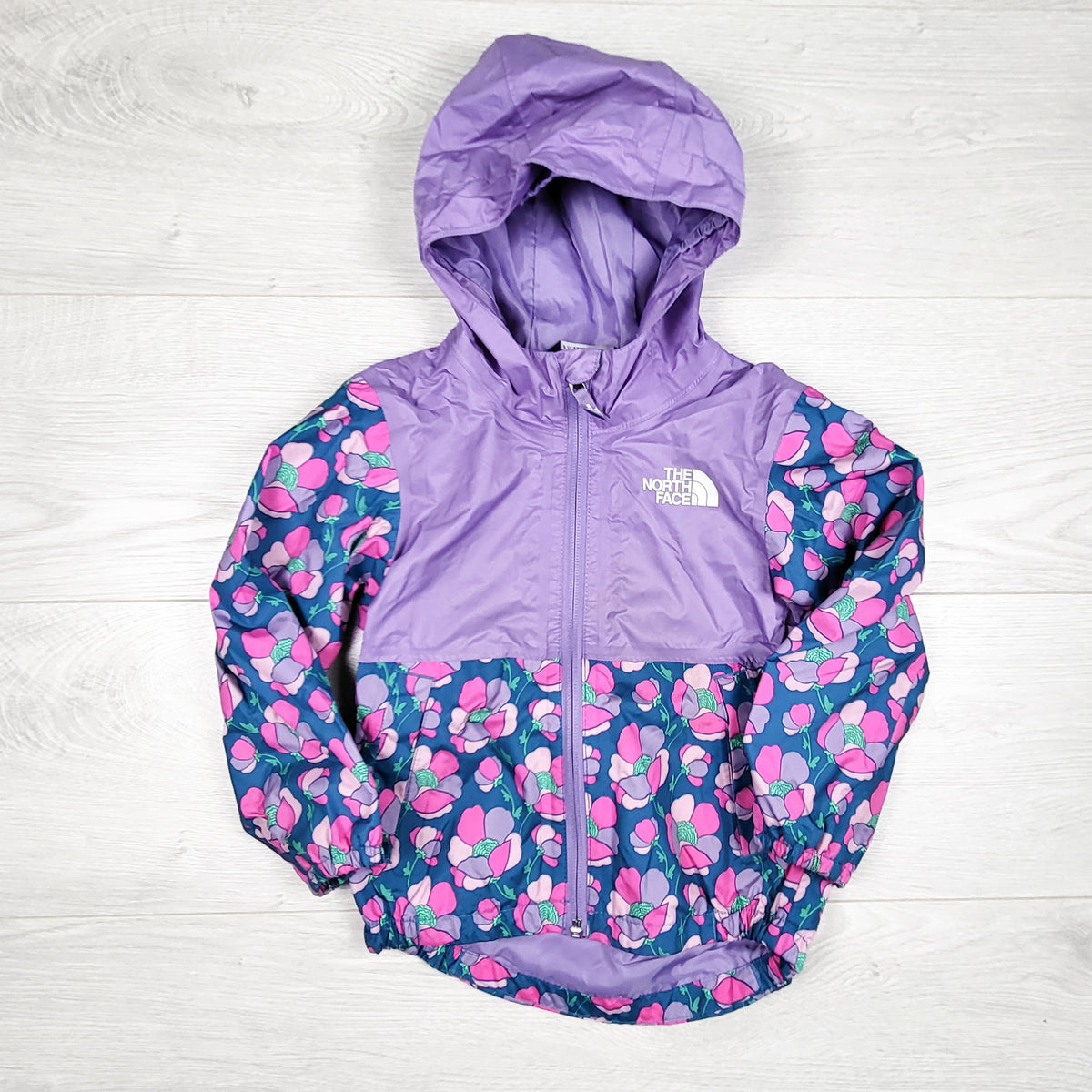 The North Face purple floral pattern Zip Line hooded rain jacket. Size 2T