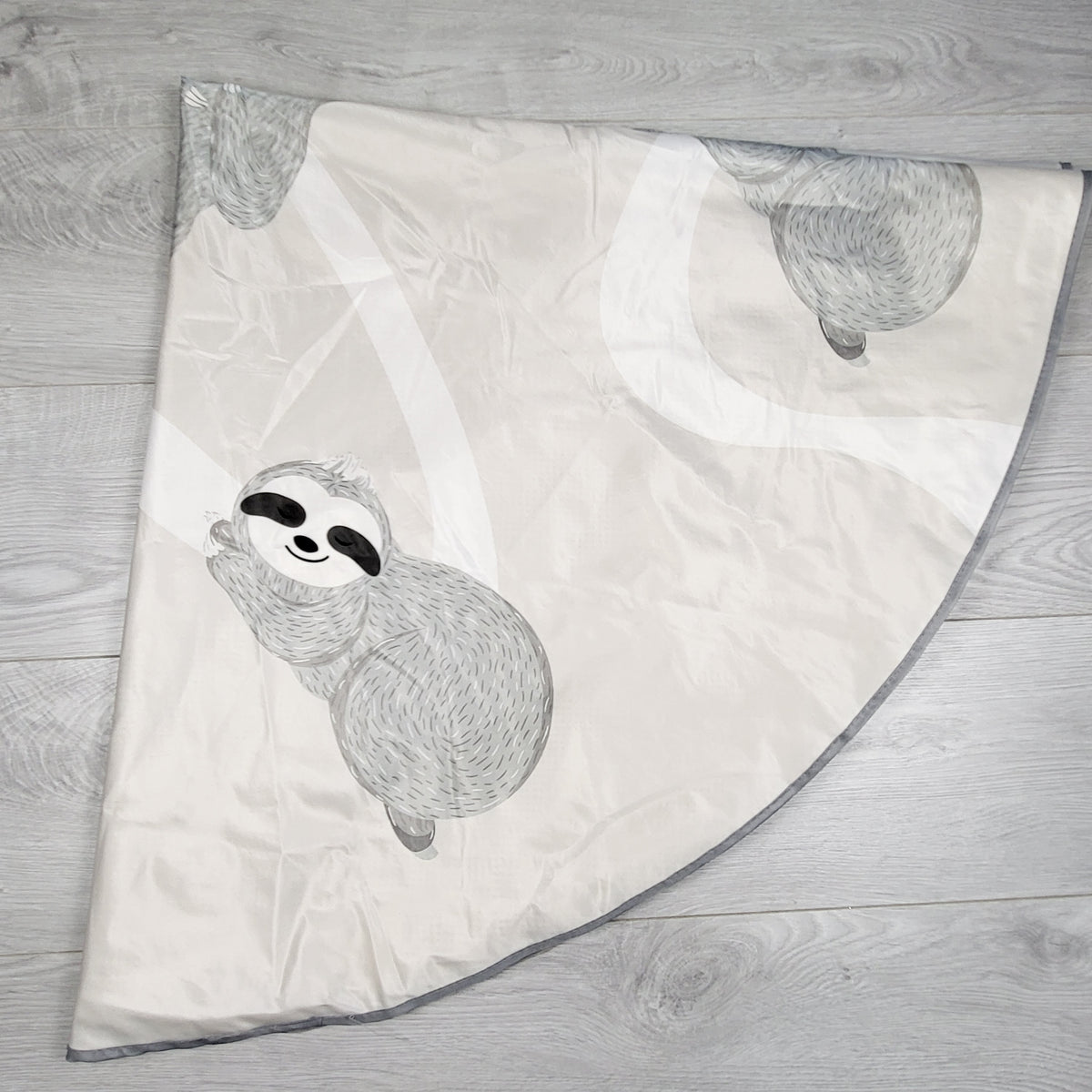 Round sloth print highchair slop mat (folded for photo purposes)