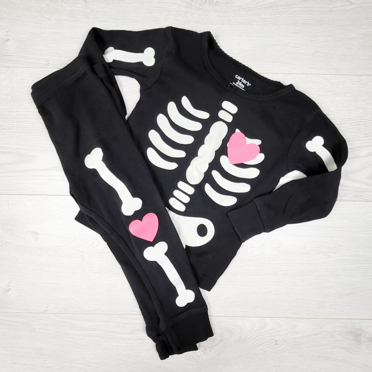 Carters black 2pc skeleton PJs with pink heart. Size 24 months