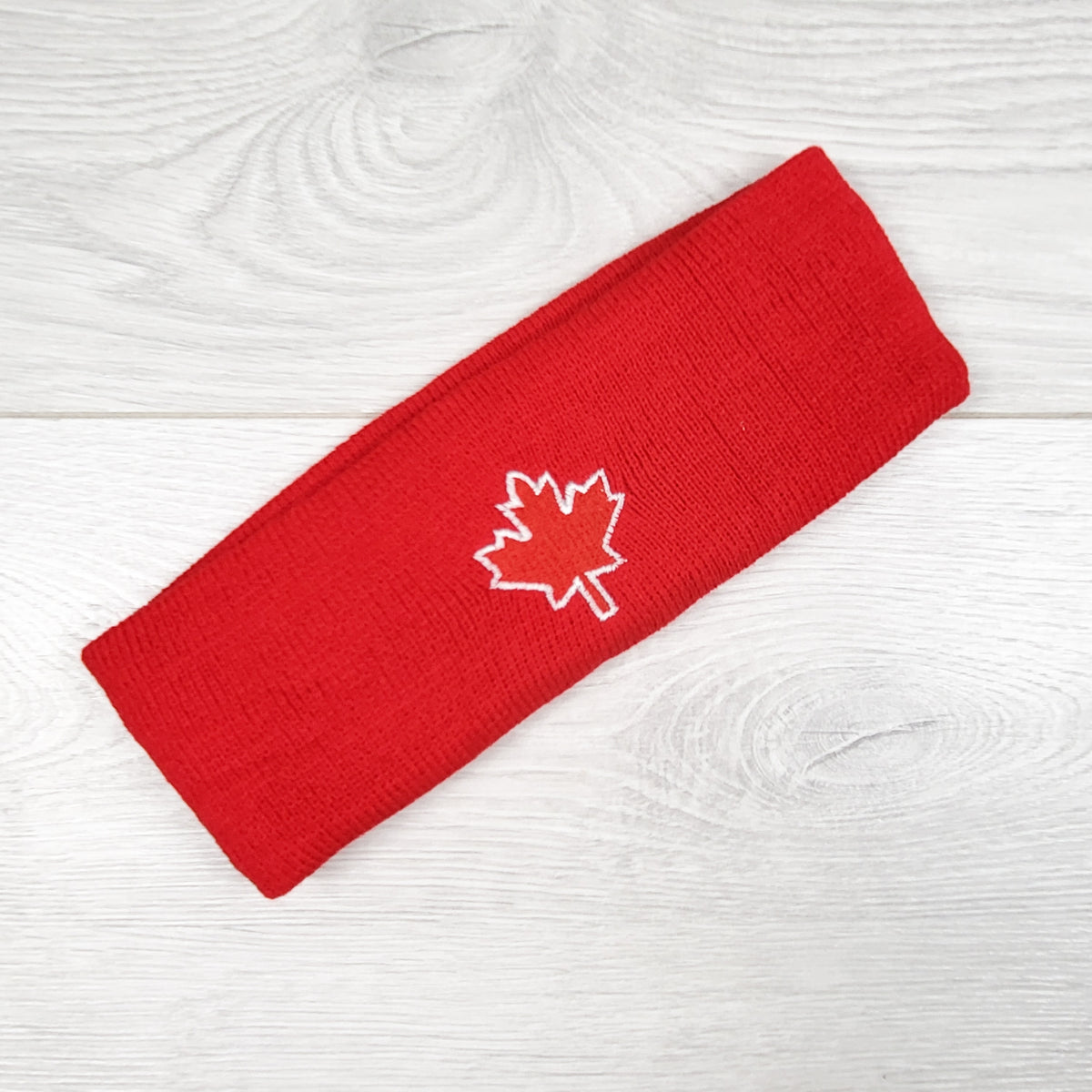 Red ear warmer with maple leaf