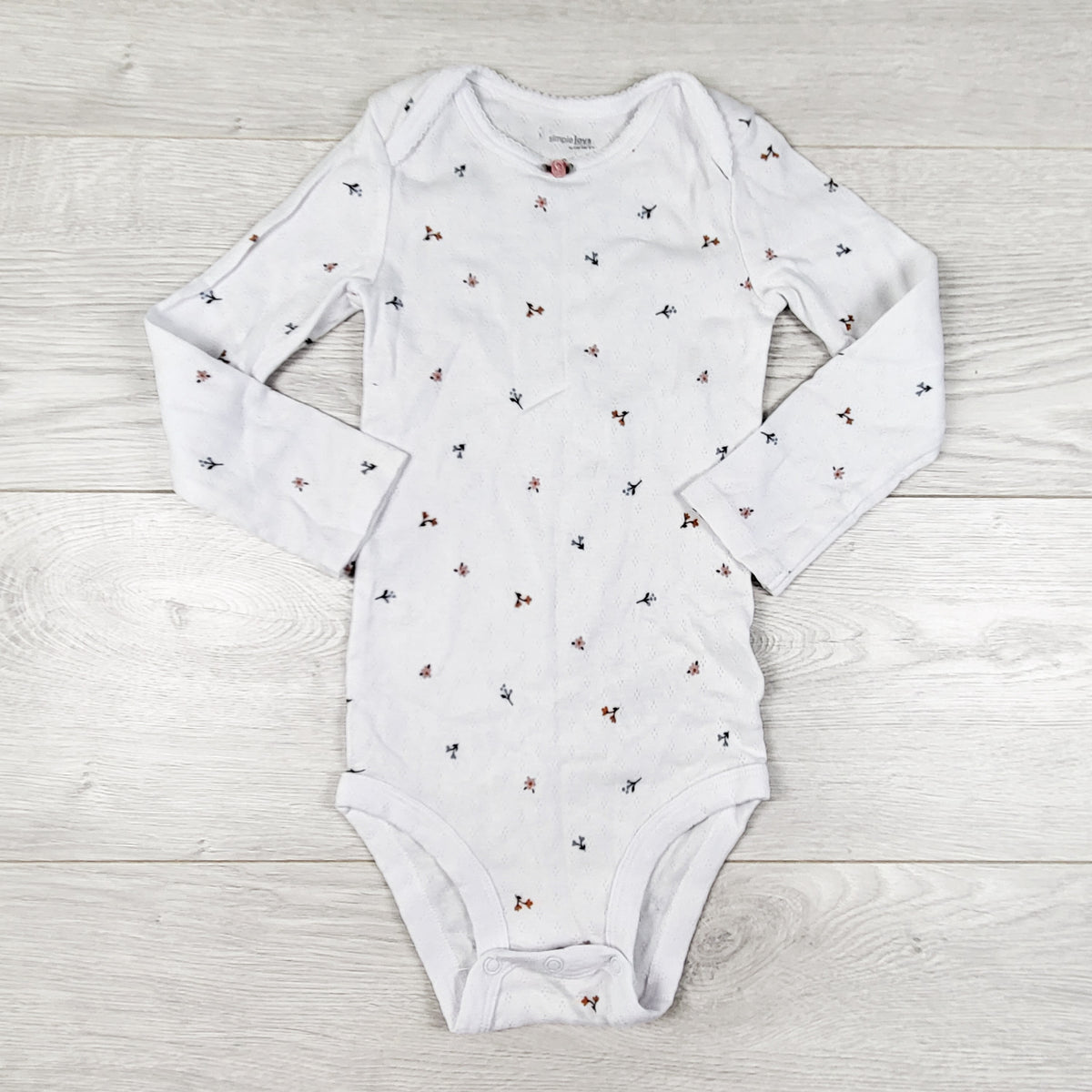 Simple Joys white floral print pointelle style bodysuit. Size 24 months
